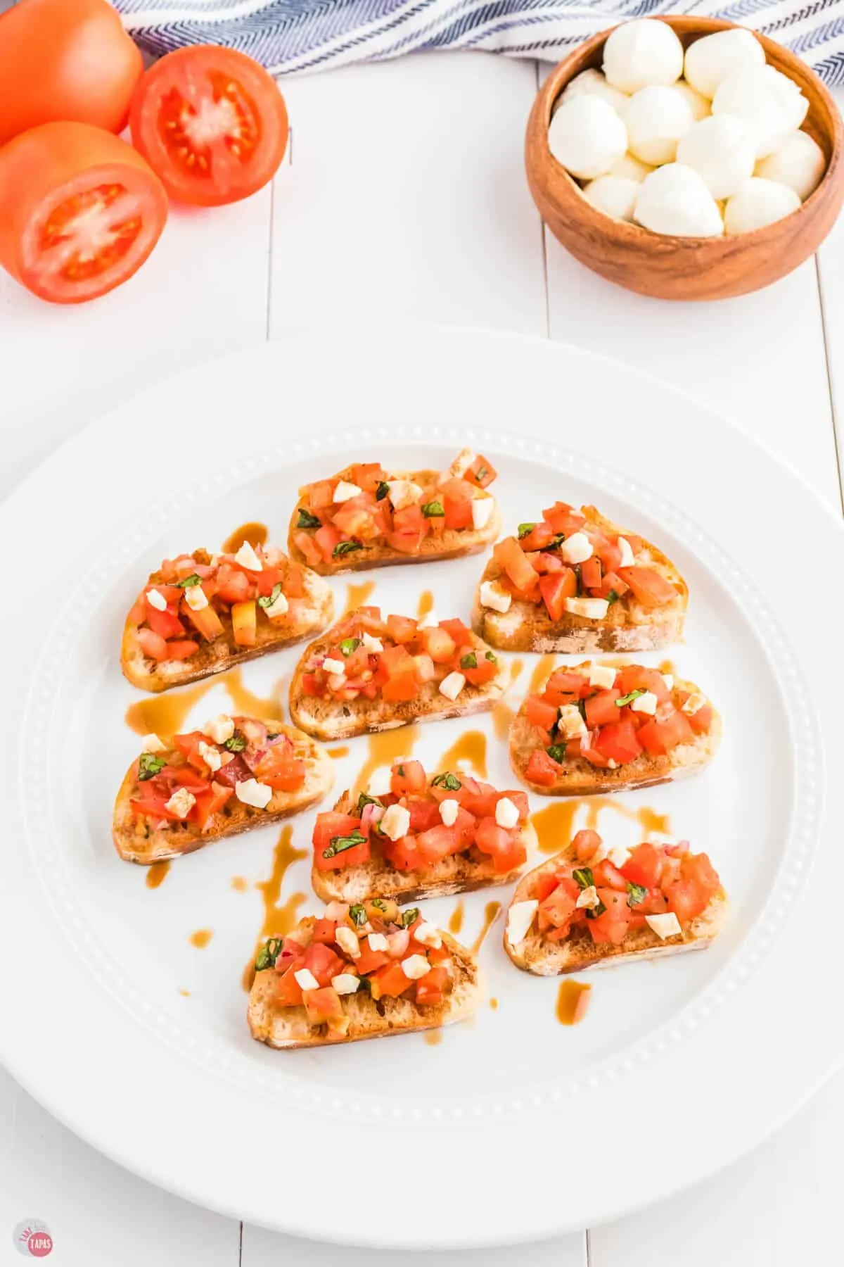 white plate with slices of tomatoes and bread