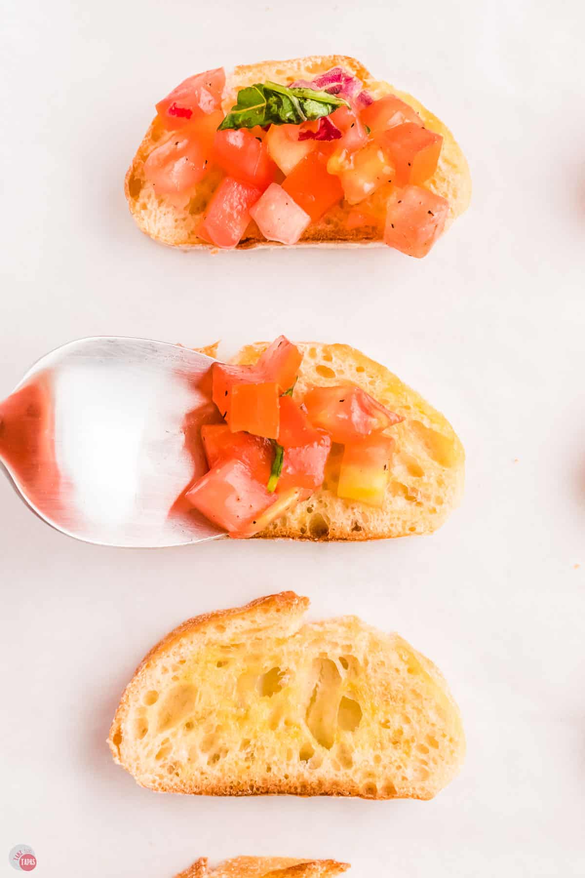 spoon with tomatoes and bread