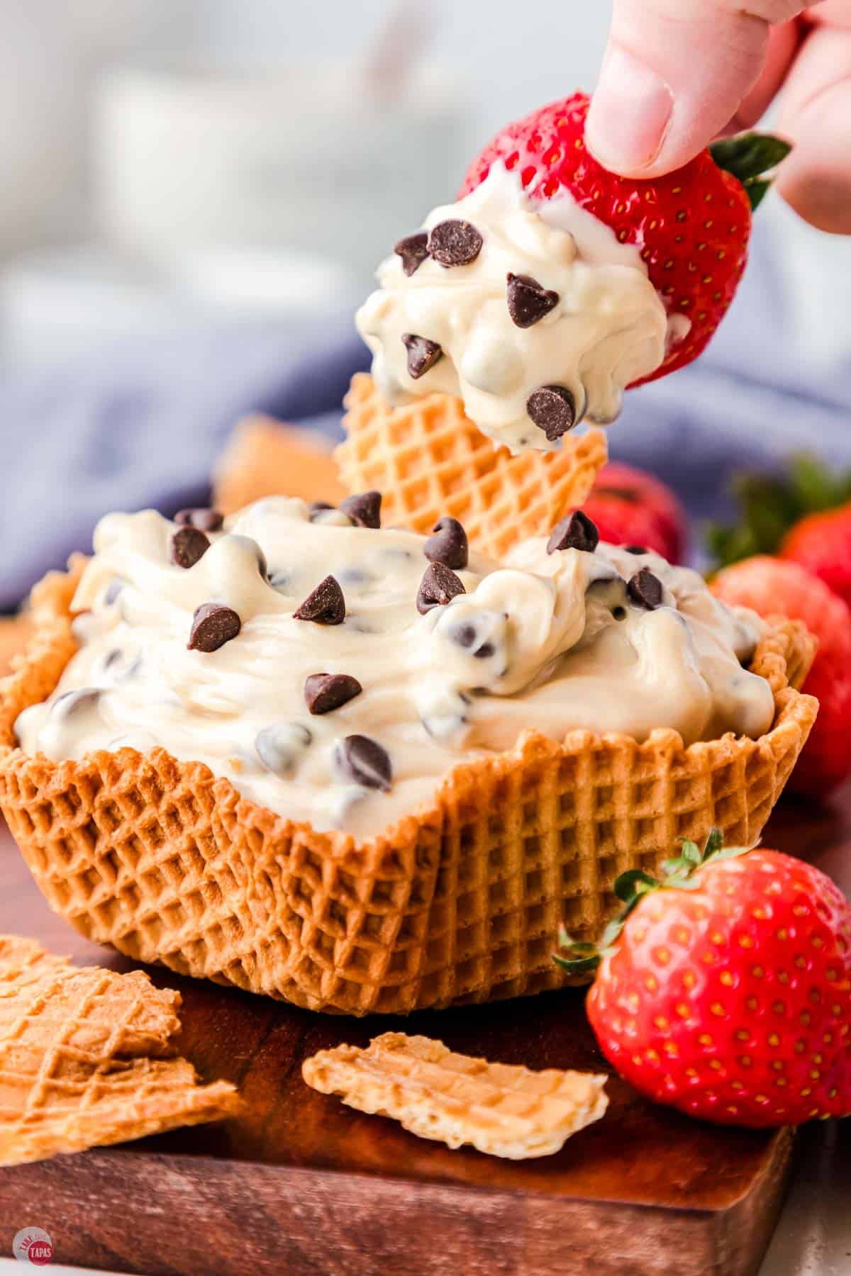 chocolate chip cream cheese dip in a waffle cone bowl