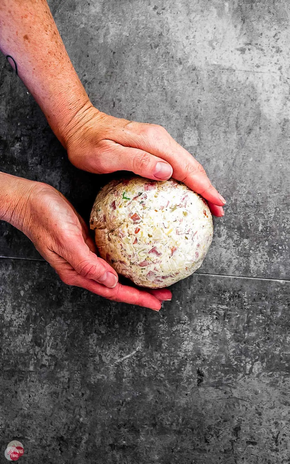 a muffuletta cheese ball with olive salad