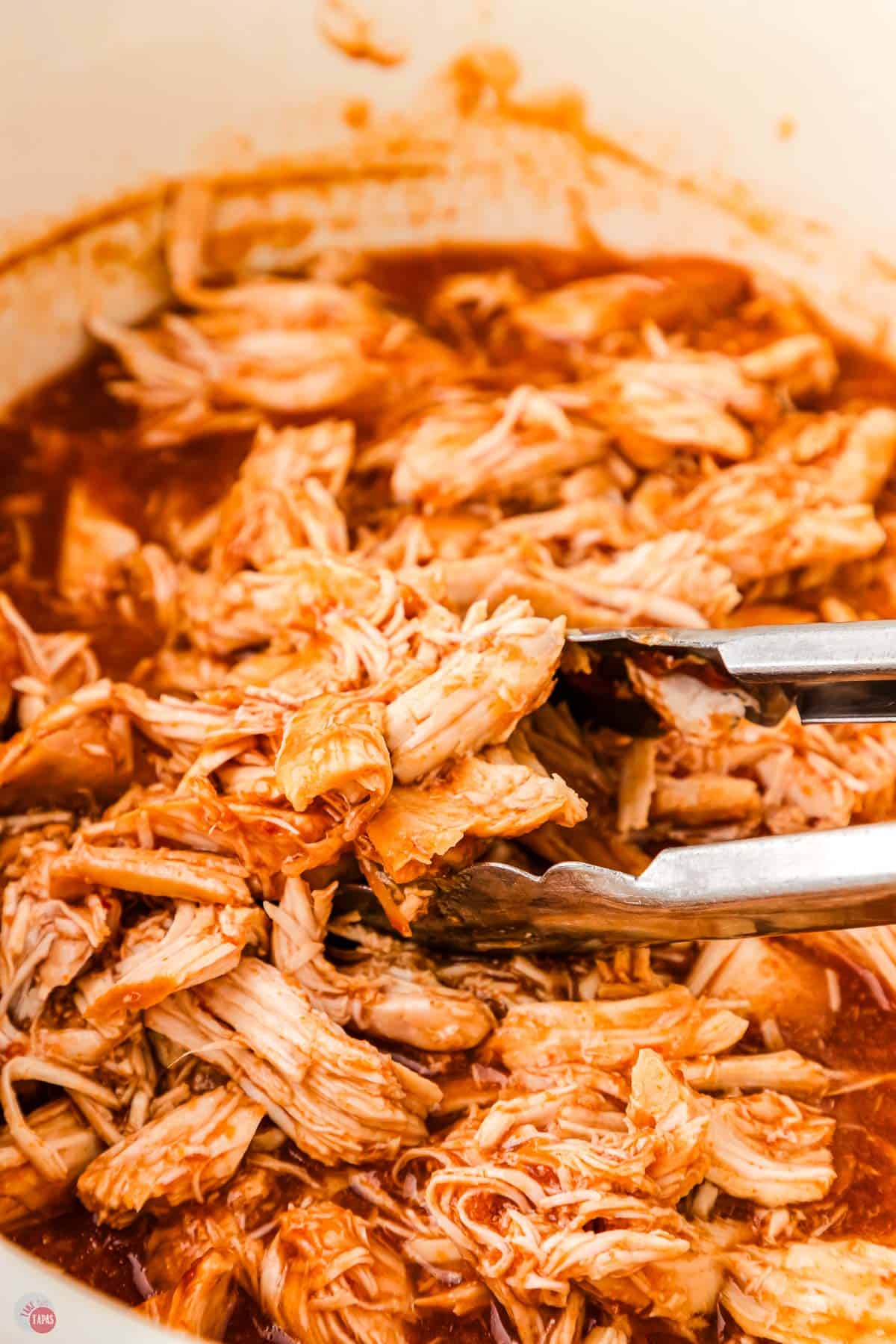 slow cooker full of shredded and pulled bbq chicken