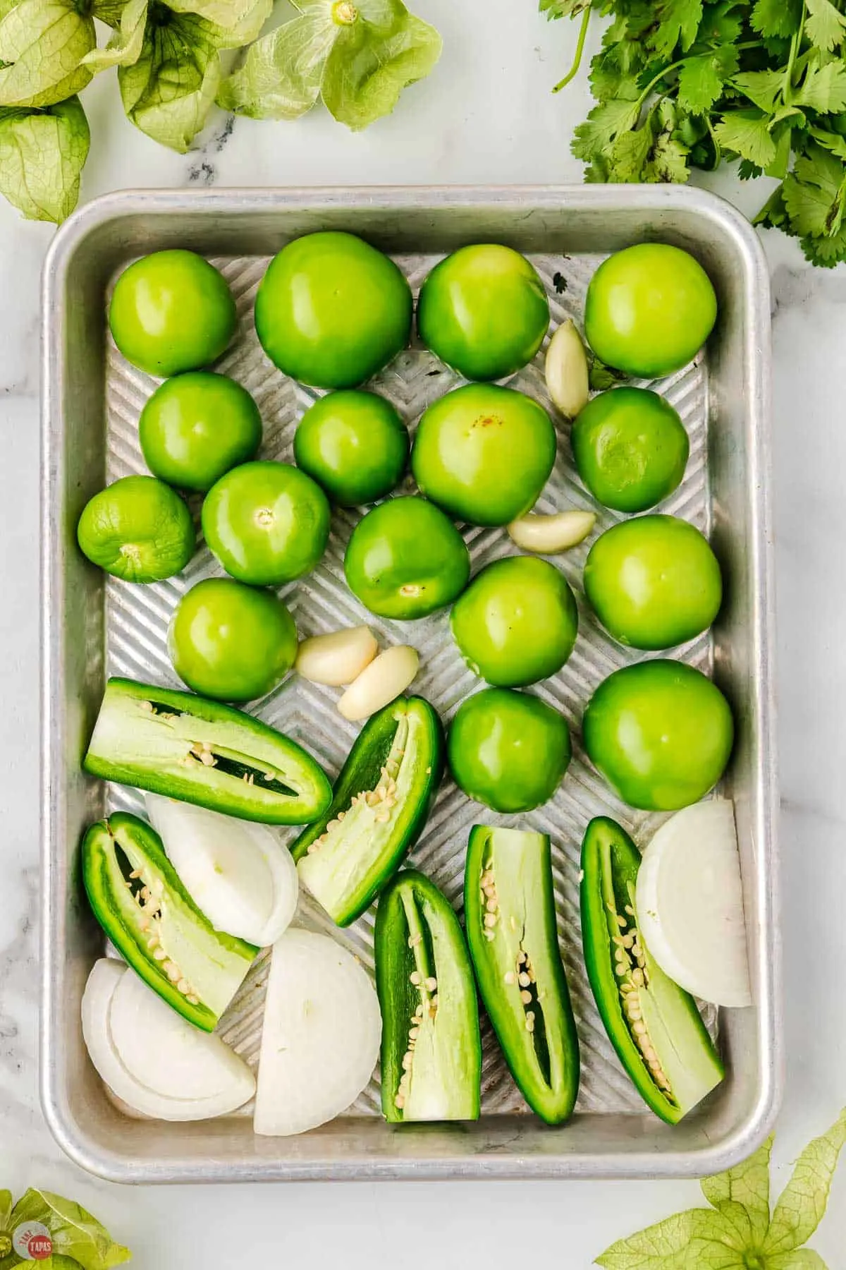 wash tomatillos and place on a rimmed baking sheet with onions and jalapeno peppers