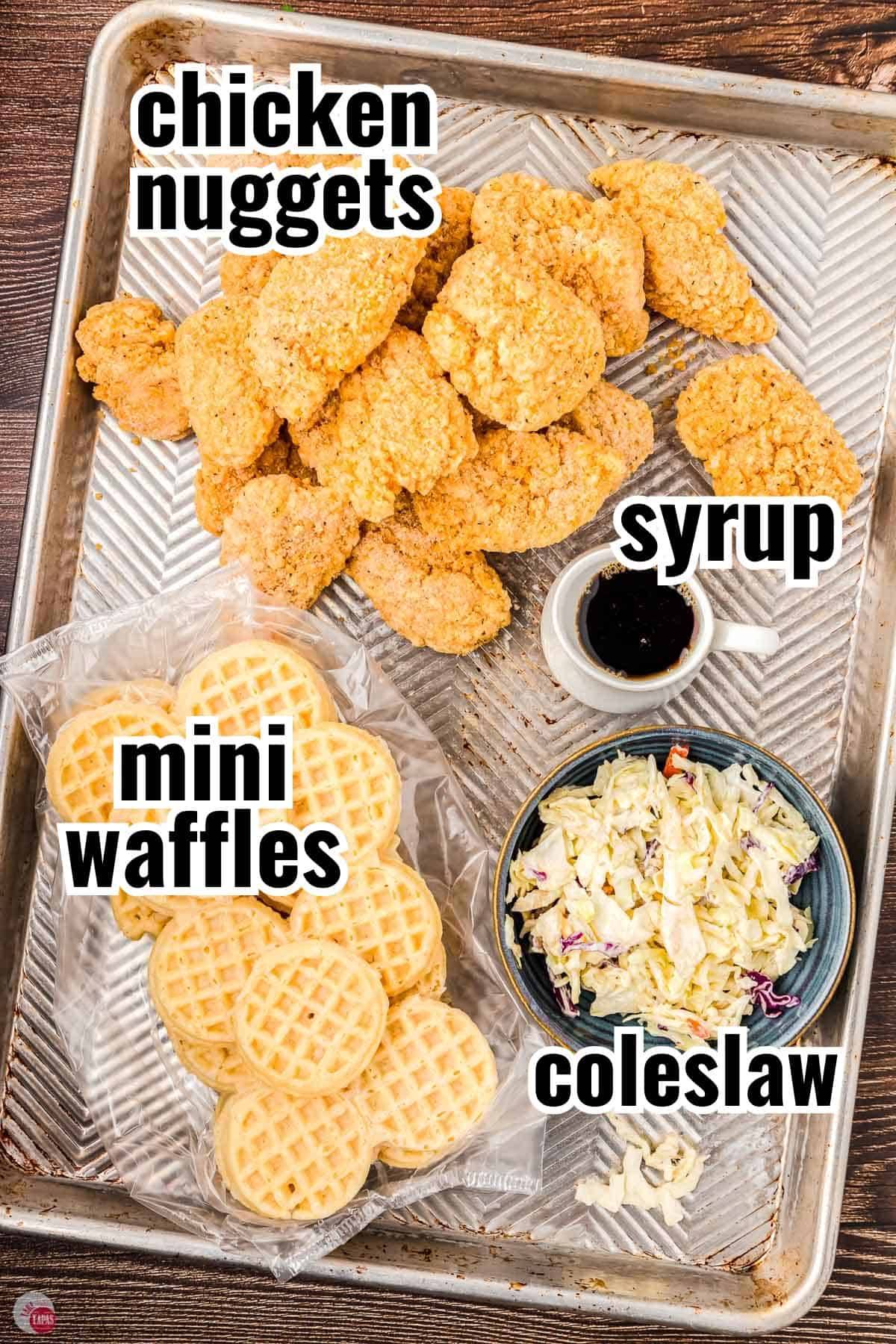 ingredients for sliders on a baking sheet with text overlay labeling them