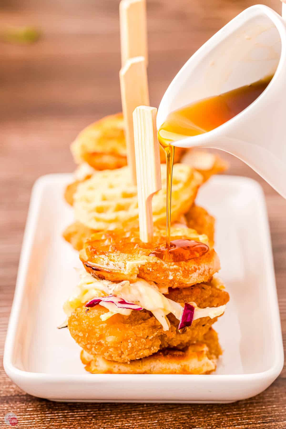 chicken and waffle sliders with a drizzle of maple syrup
