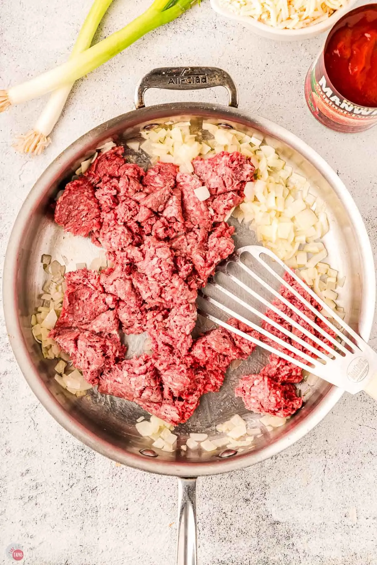 cook the onions and ground beef in a pan