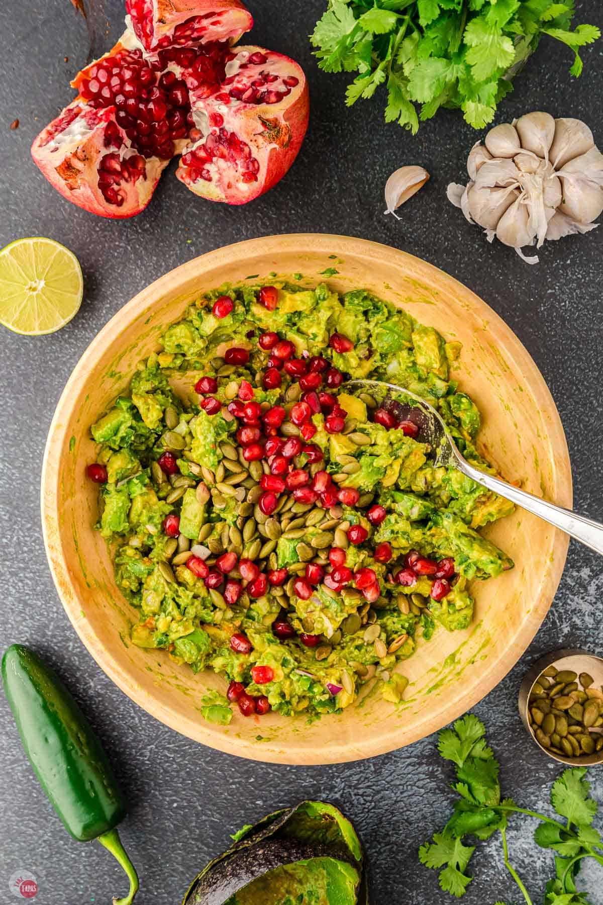 sprinkle pomegranate arils on top of the guacamole