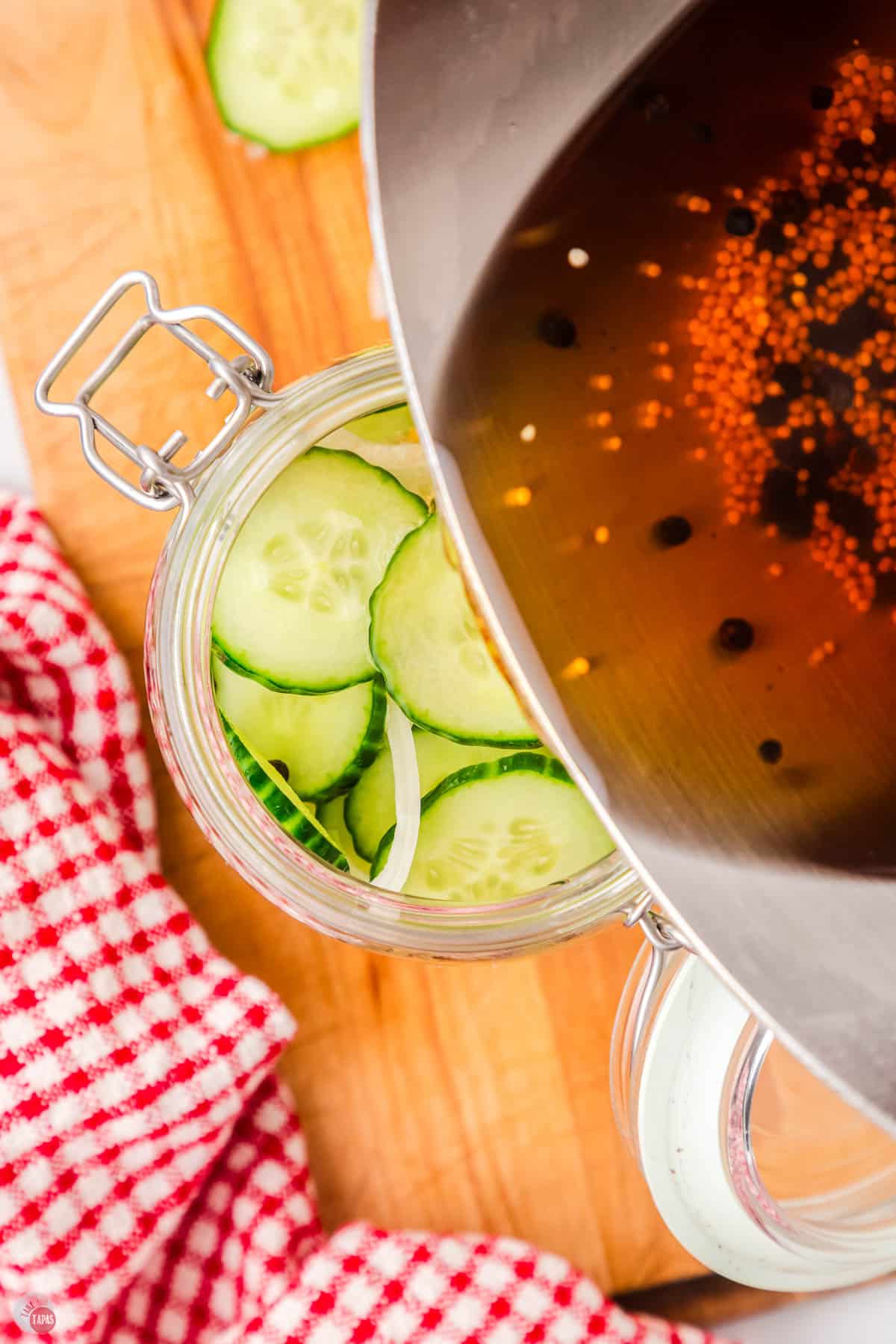 pouring brine with mustard seeds in a jar