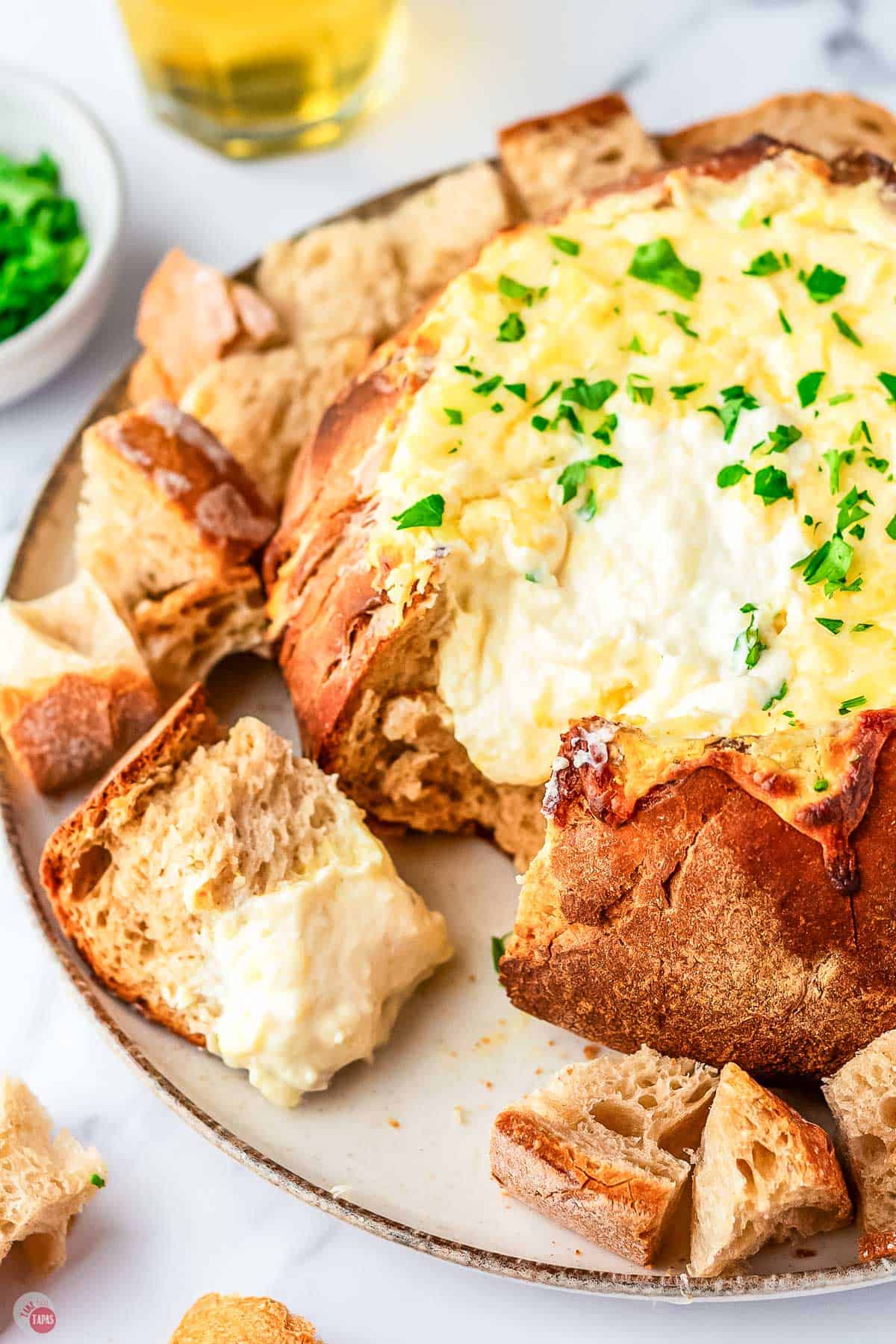 melted cheese pouring out of a bread bowl