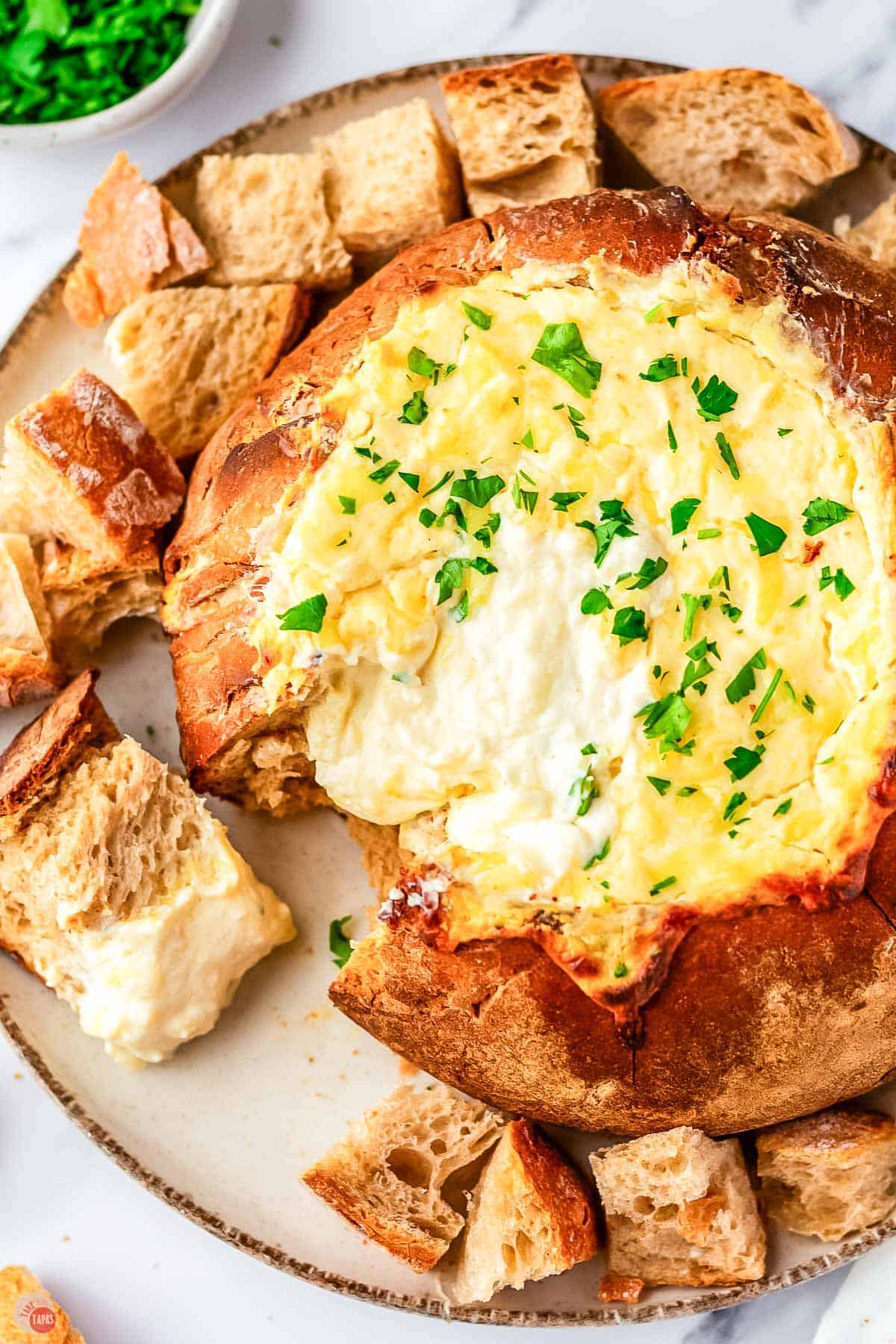 overhead picture of a bread boule filled with melted cheese