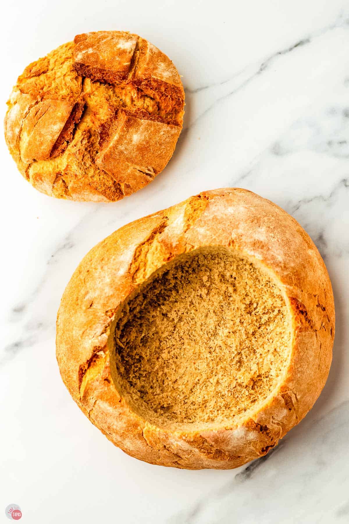 bread boule with the center cut out to make a bowl