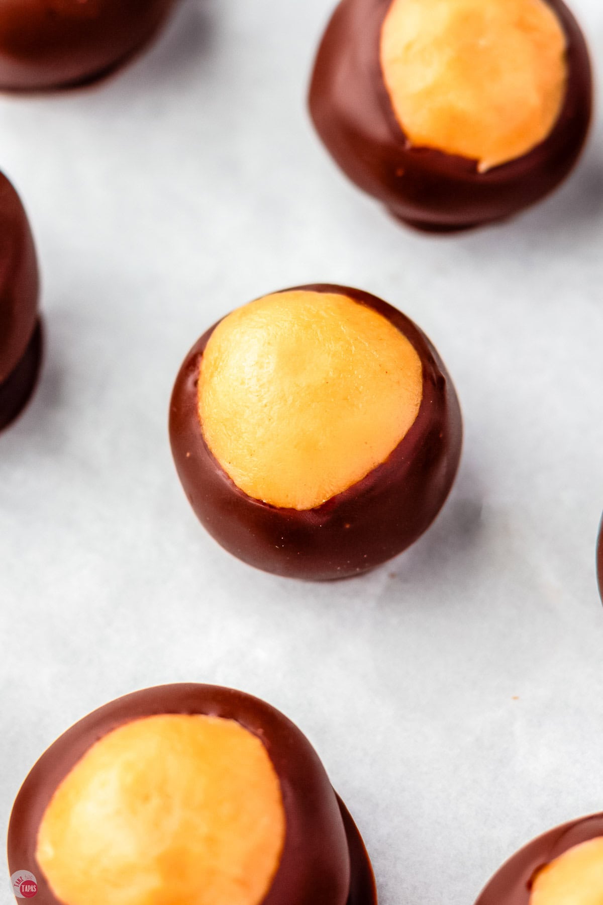 close up of buckeyes on a piece of parchment paper