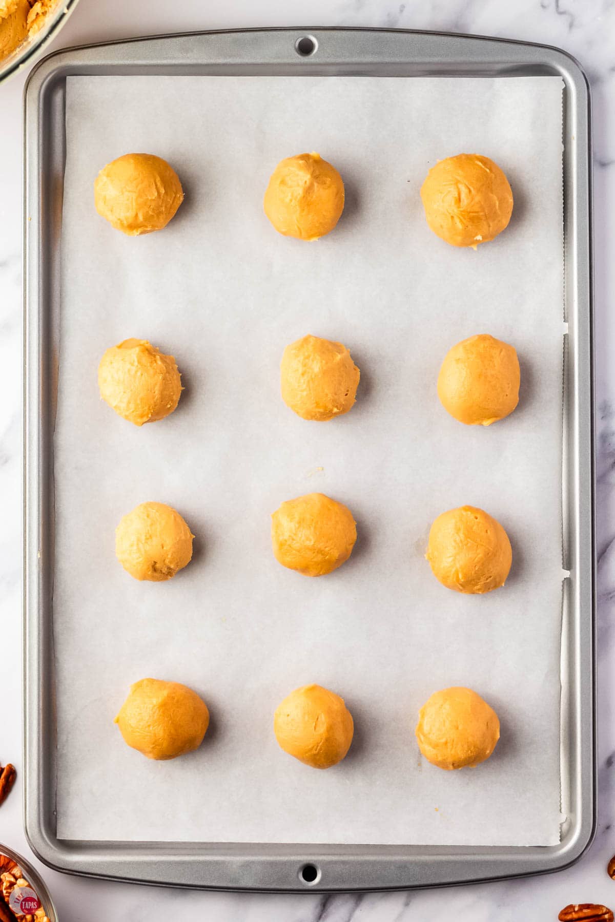 peanut butter balls on a baking sheet with parchment paper