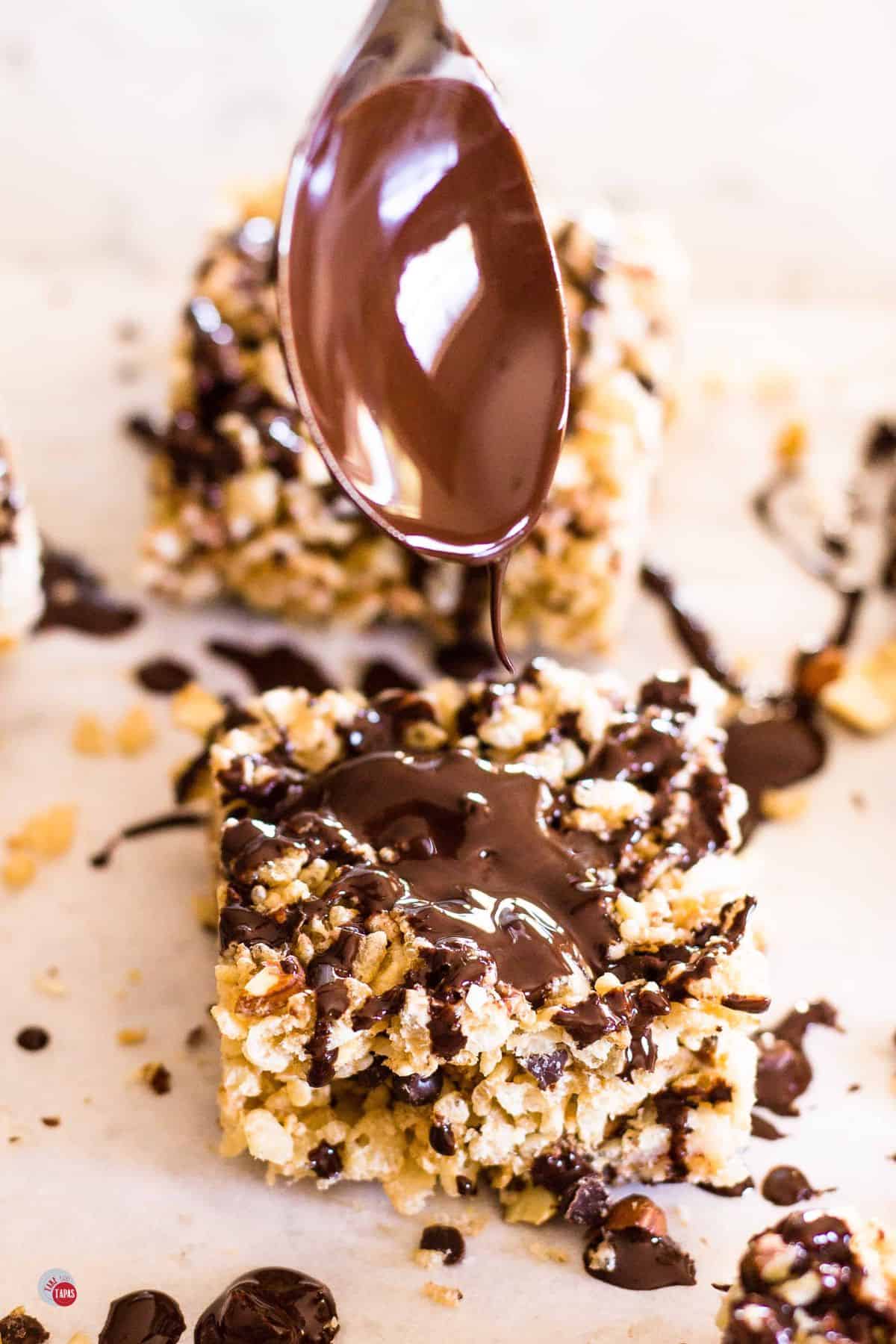 spoon drizzling chocolate on cereal
