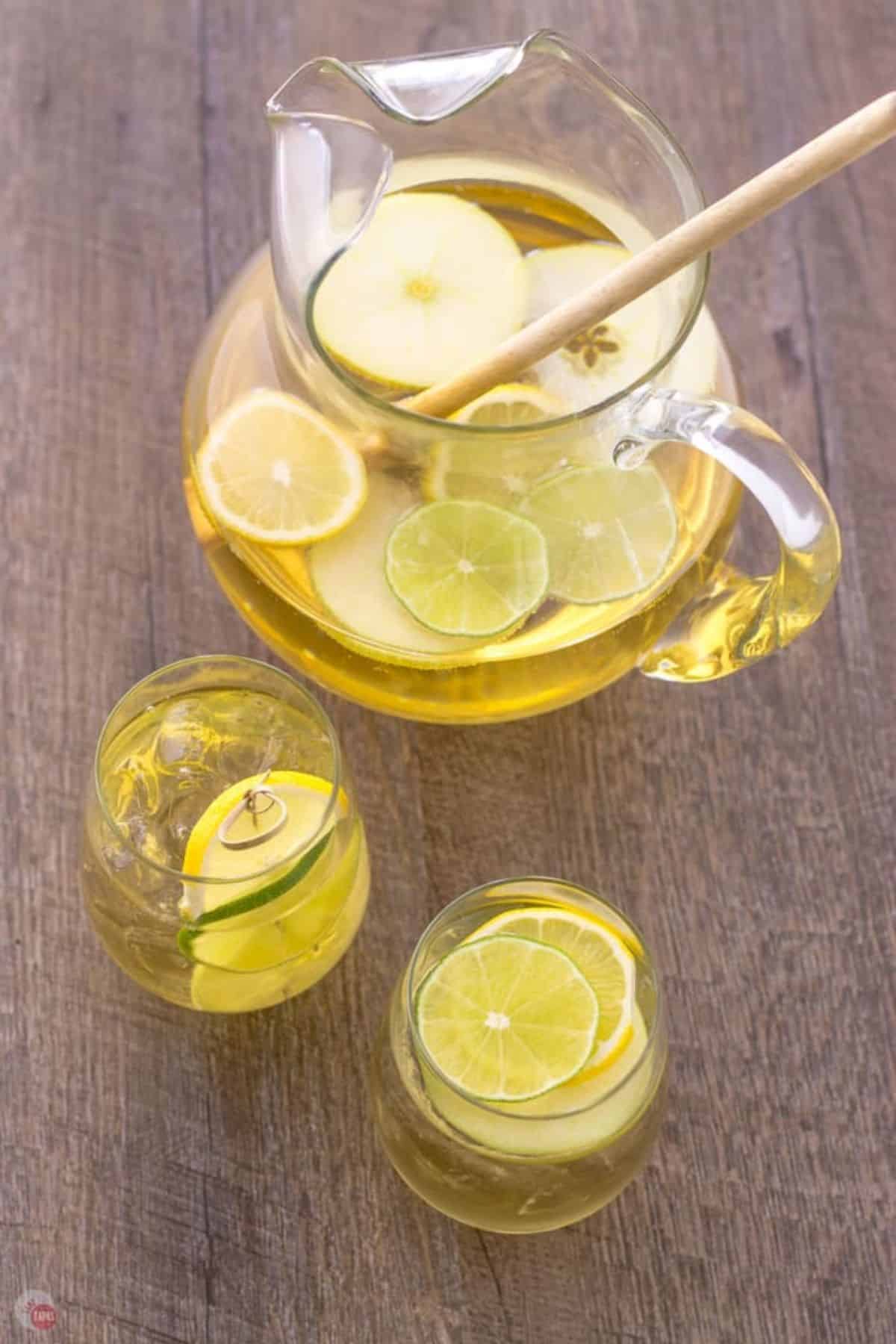 glasses of apple sangria next to a pitcher