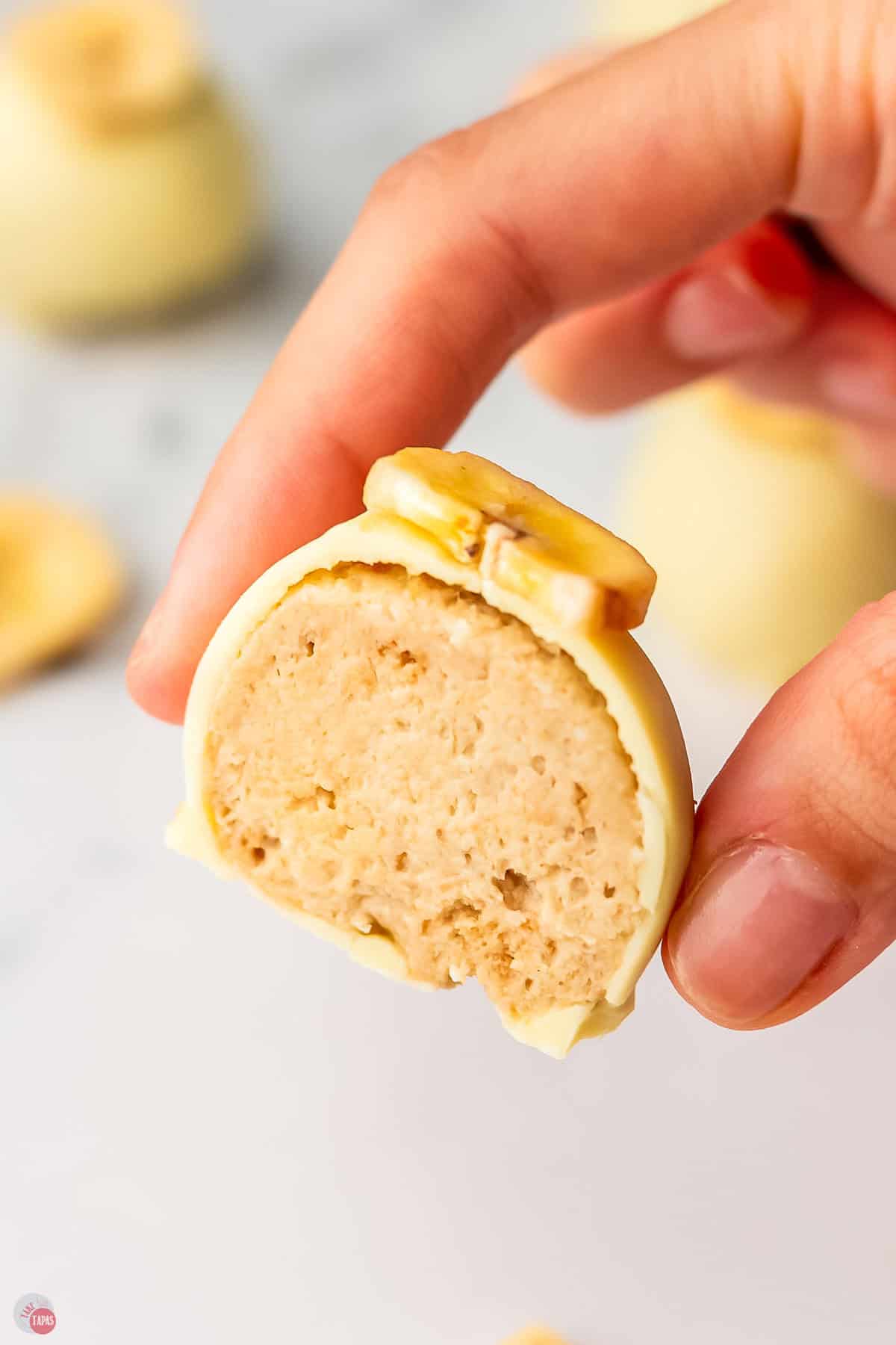 hand holding a truffle that is cut in half