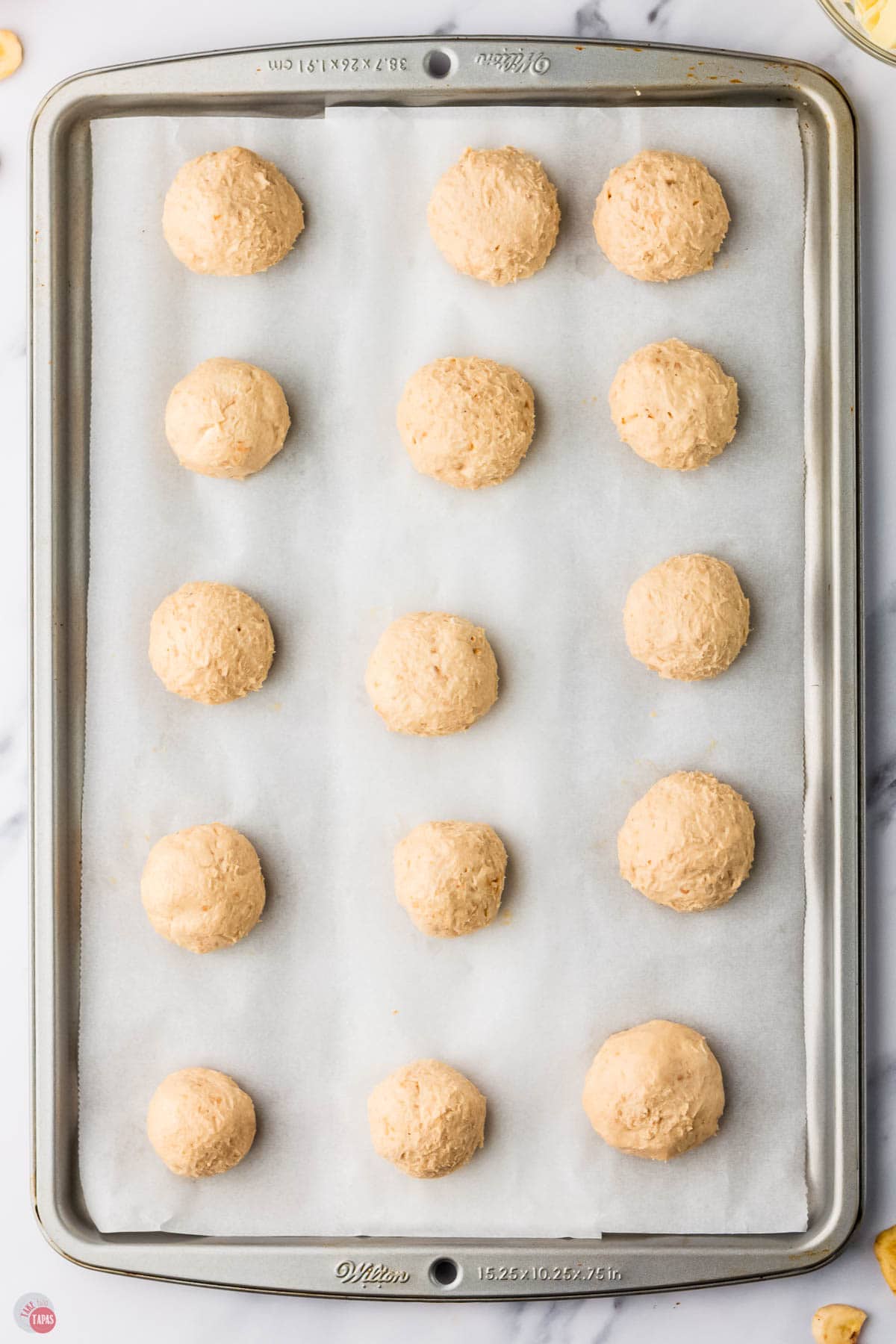 truffle mixture scooped into balls on a baking sheet