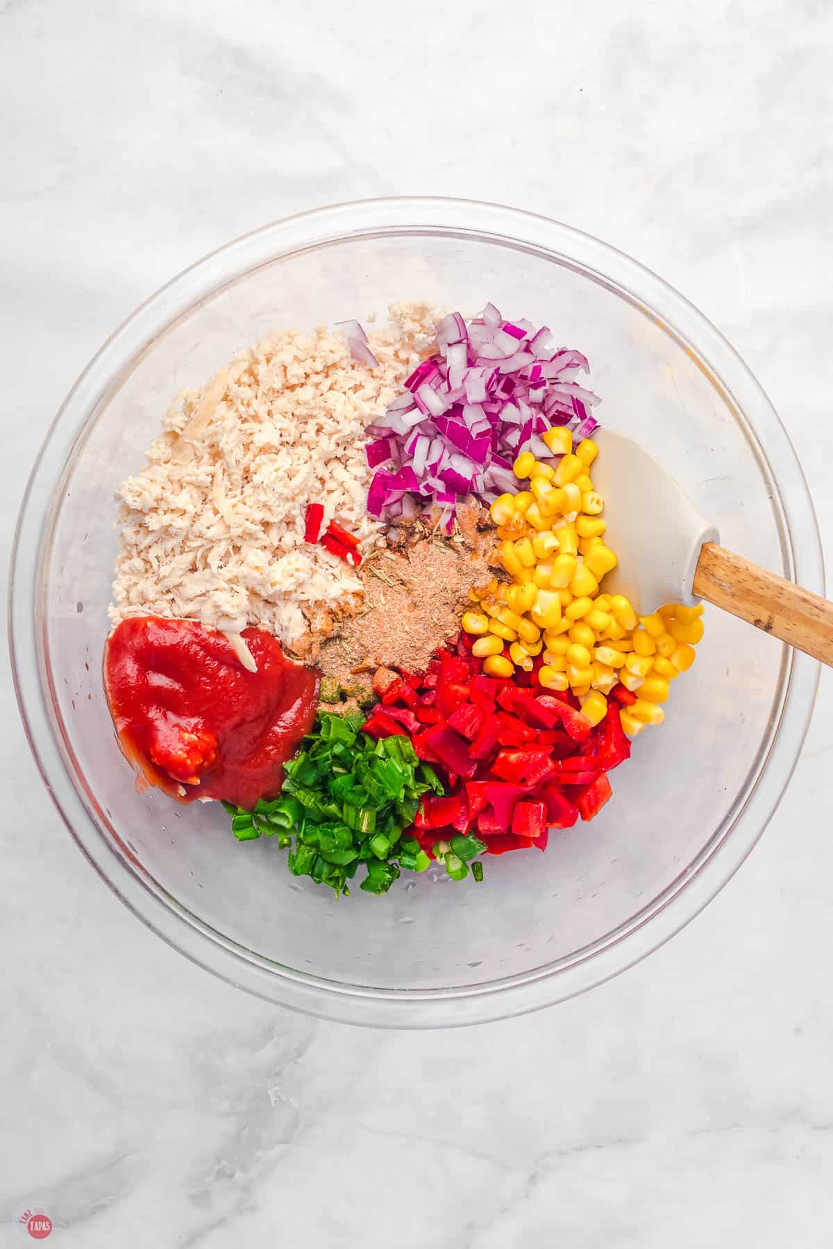 quesadilla ingredients in a clear bowl with a spatula
