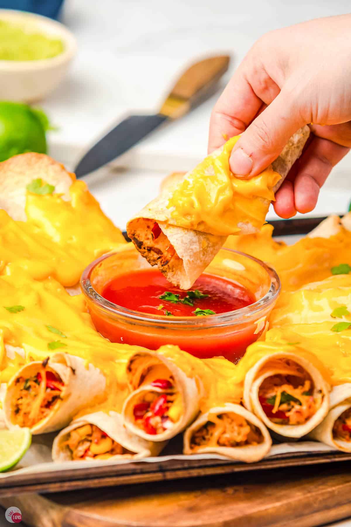 quesadilla ring being dipped in cheese sauce