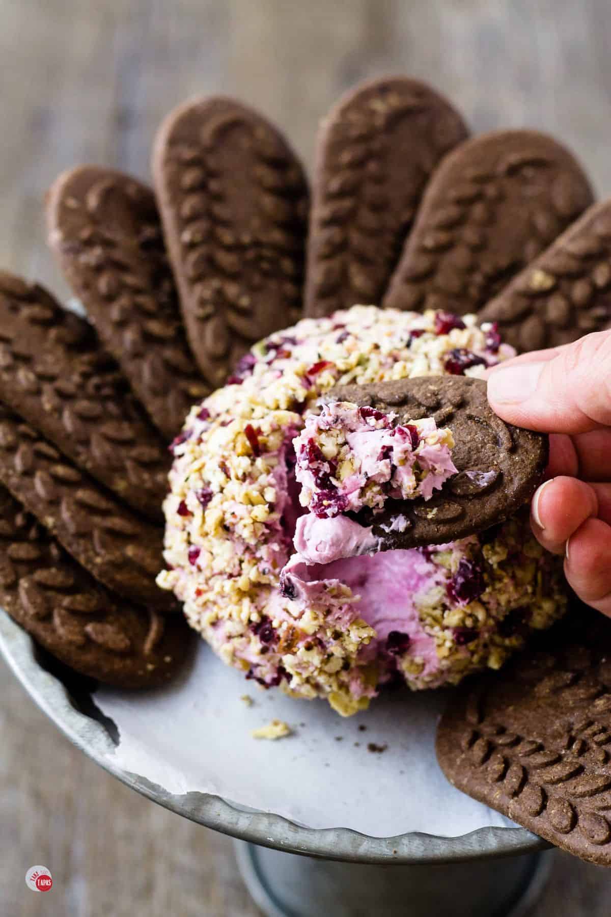 blackberry cheese ball with cookies around it