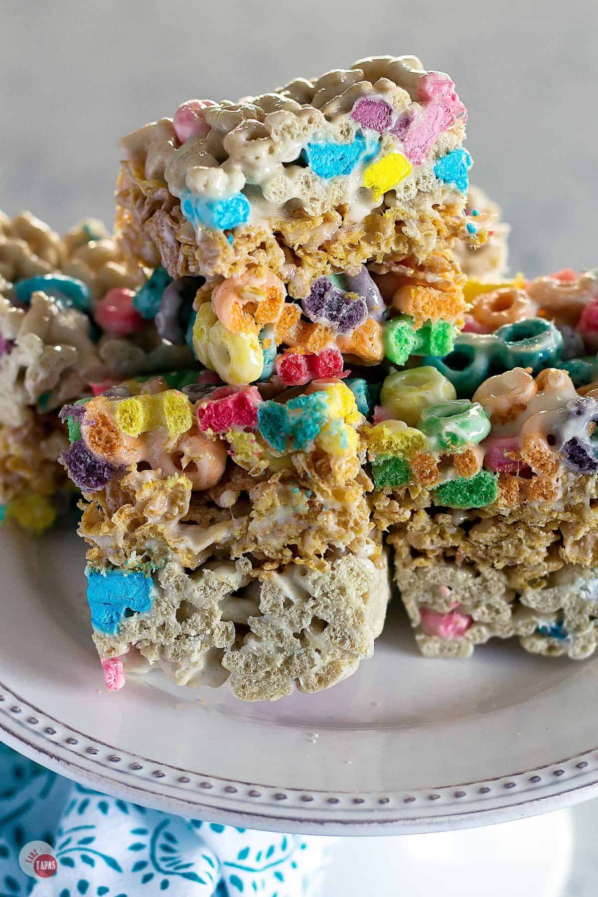 layered cereal bars on a white cake plate