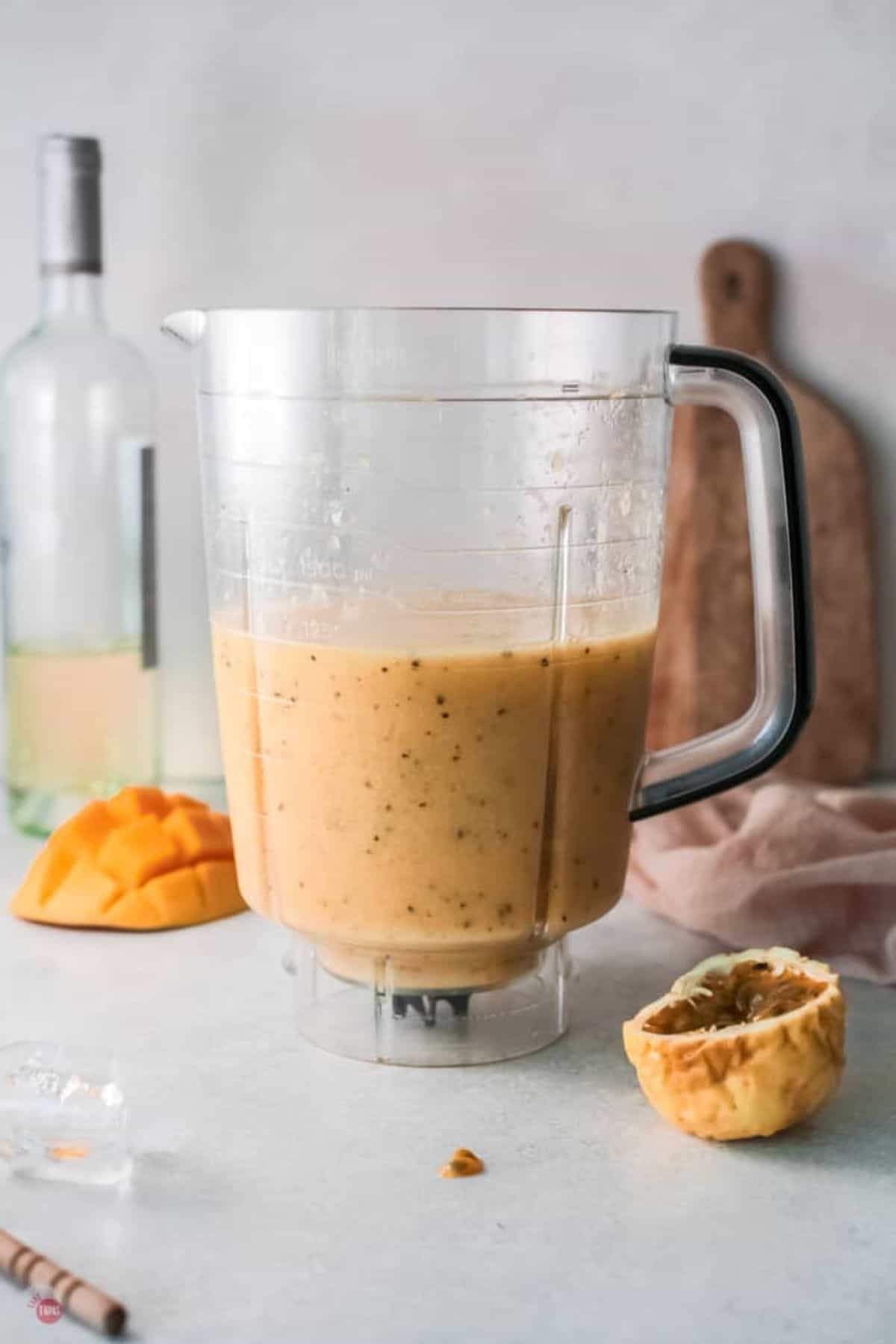 blender with fruit smoothie in it.