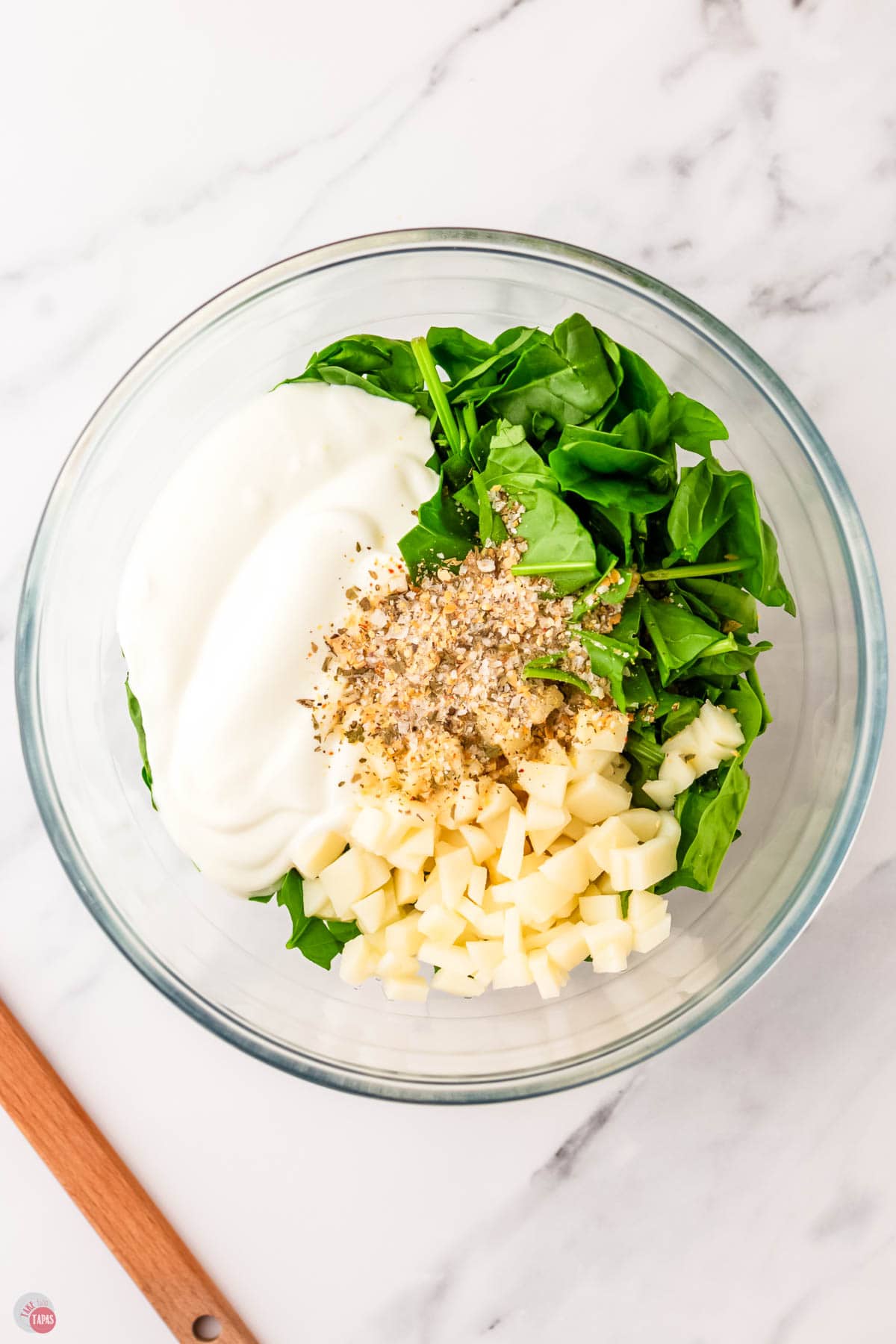 spinach and sour cream in a bowl with spices and water chestnuts