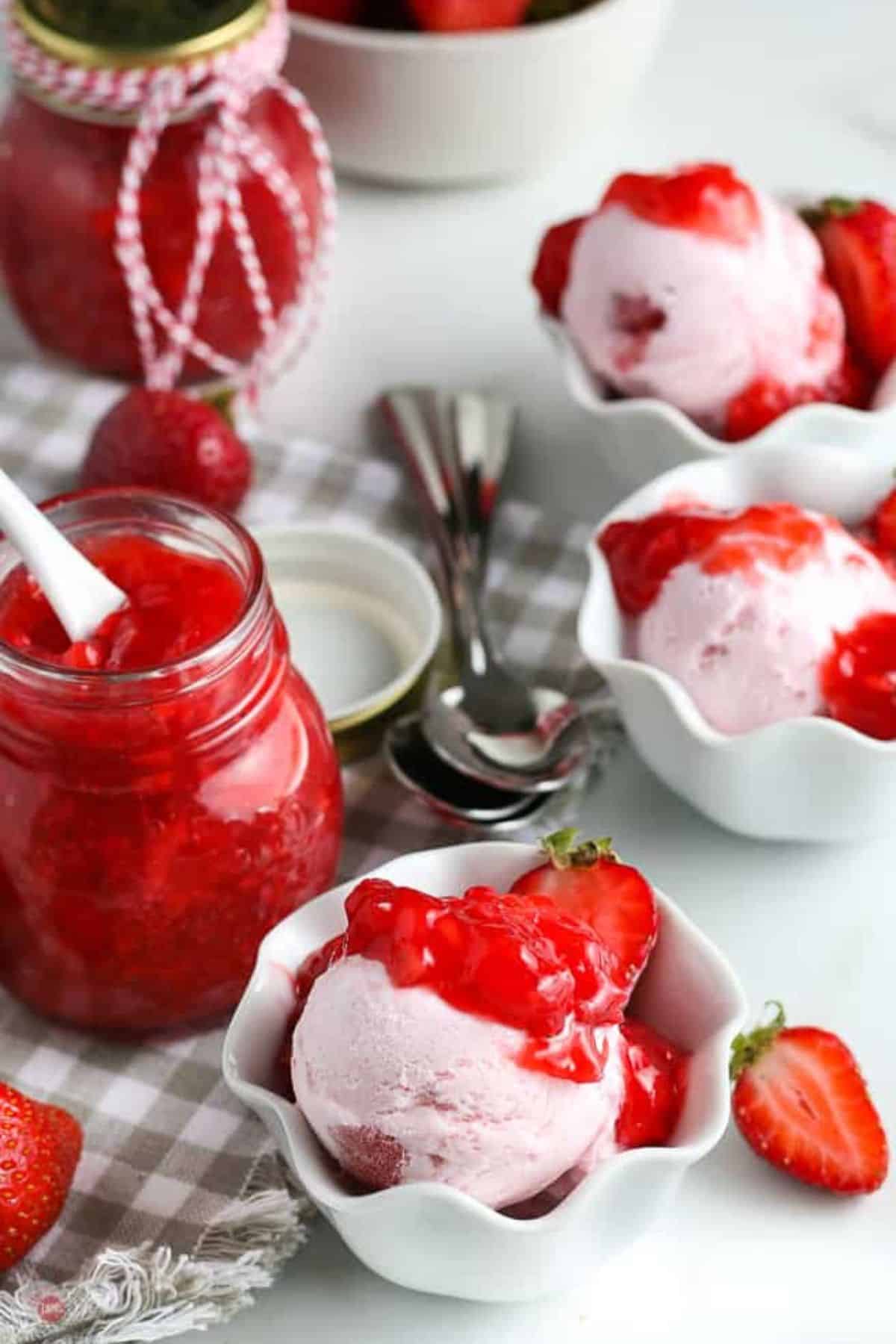 bowl of ice cream with strawberry sauce on it