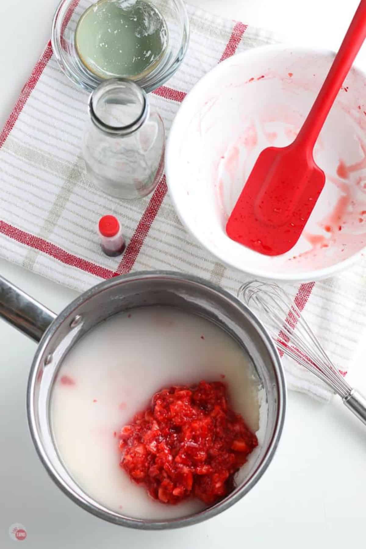 pot with sugar, water, and strawberries