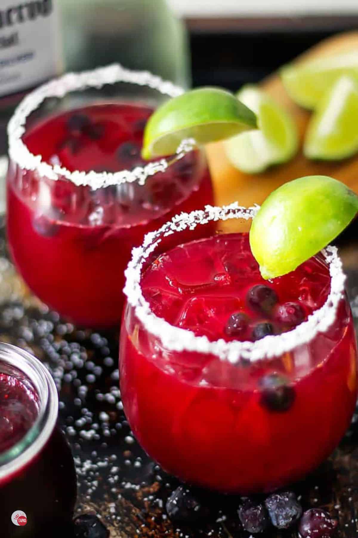 two glasses of blueberry margarita with salt