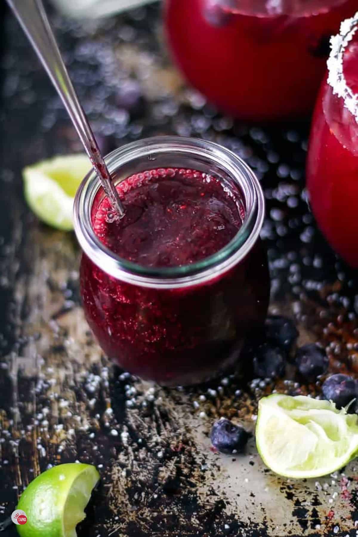 jar of blueberry puree with a spoon in it