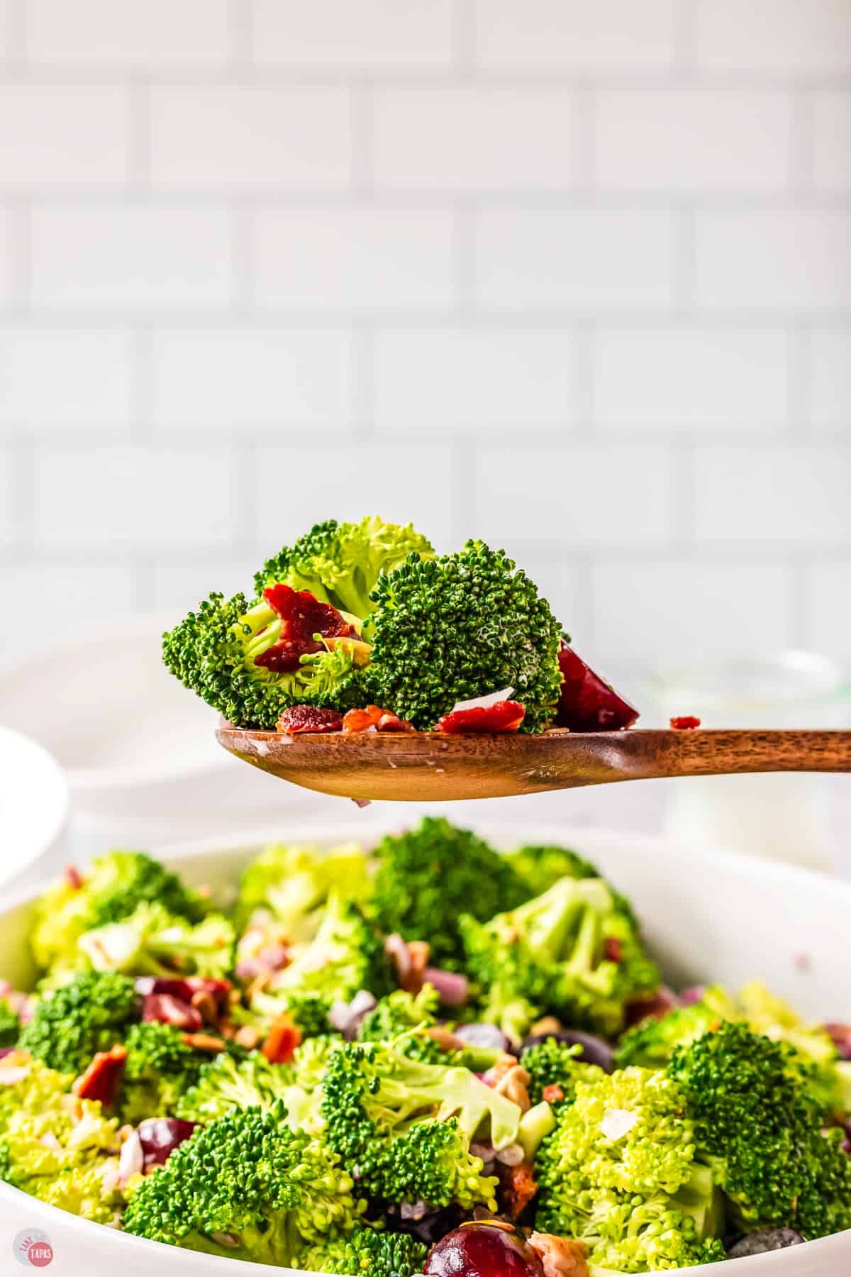 side view of wood spoon with broccoli on it