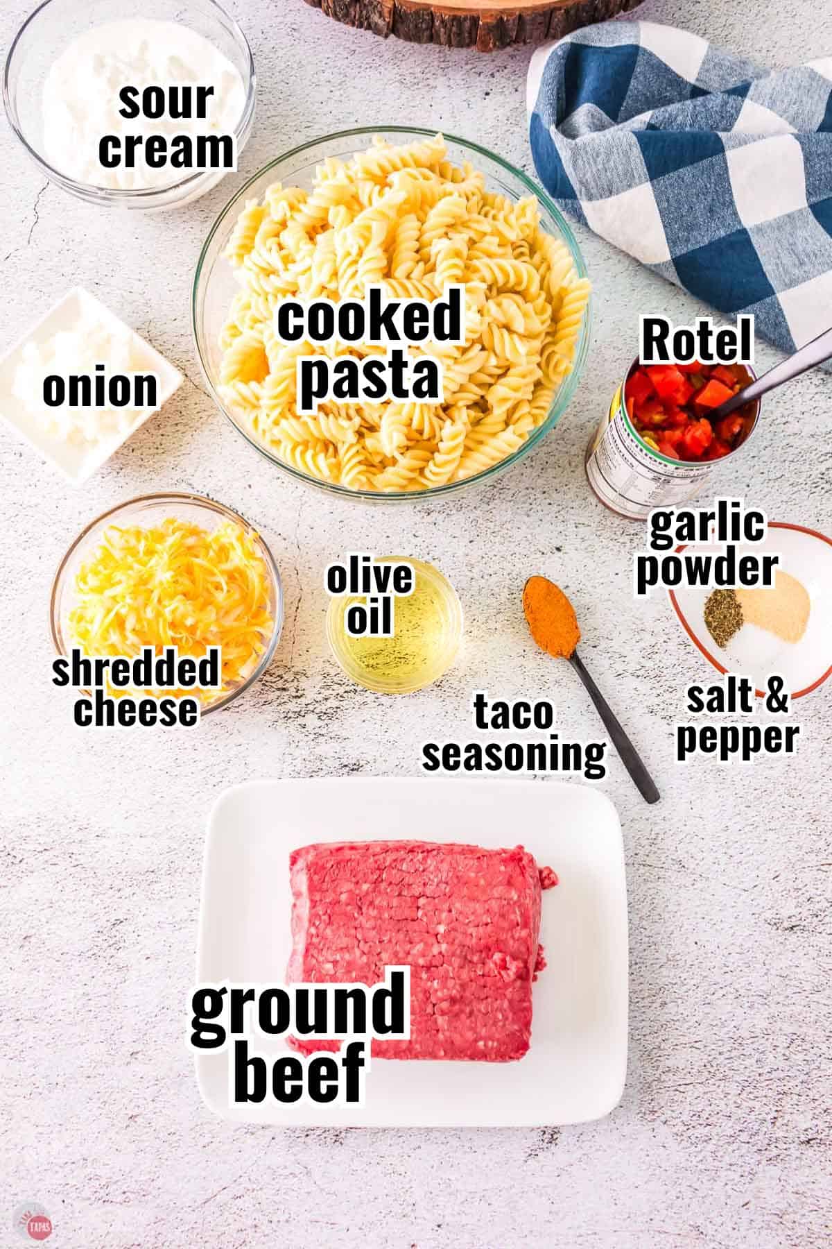 ingredients for a pasta skillet meal in individual bowl with text overlay labeling them