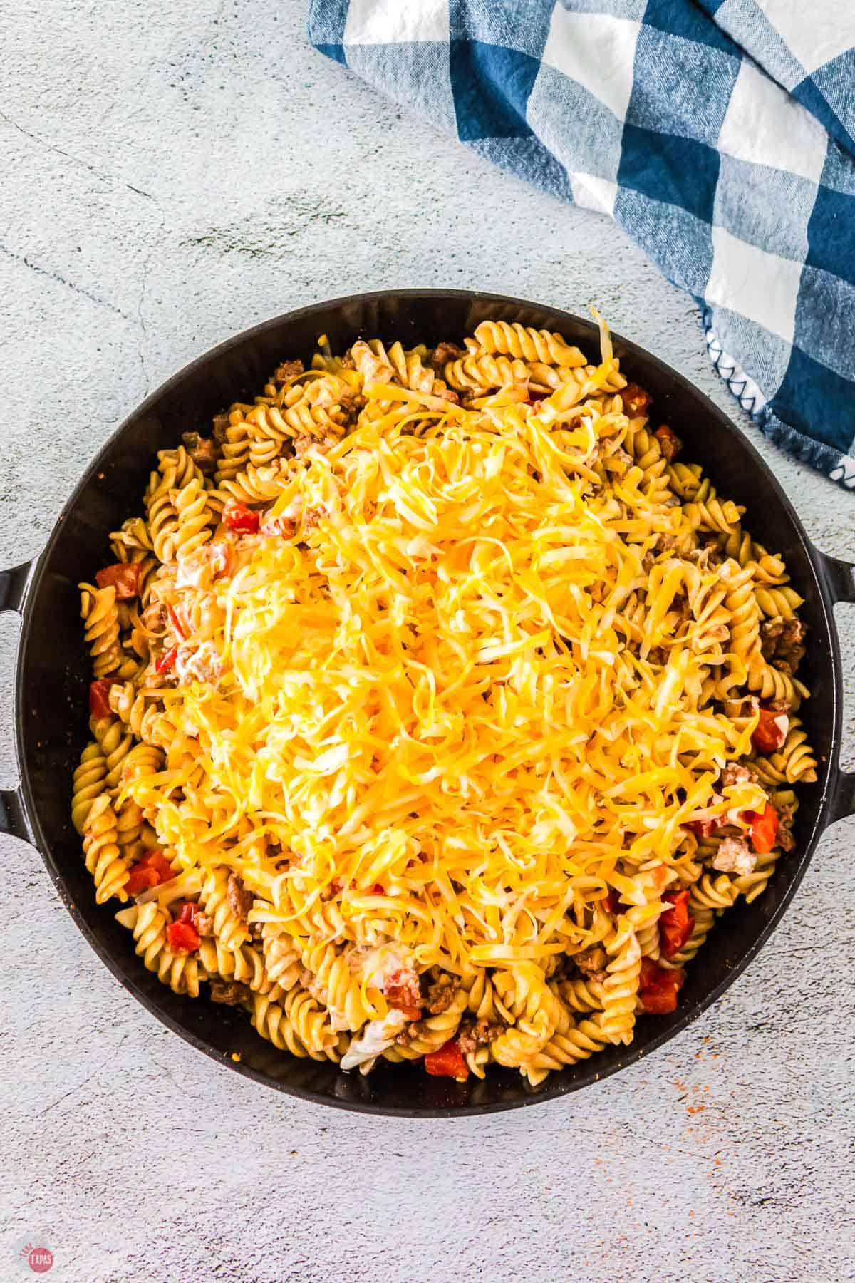past in a skillet topped with shredded cheese