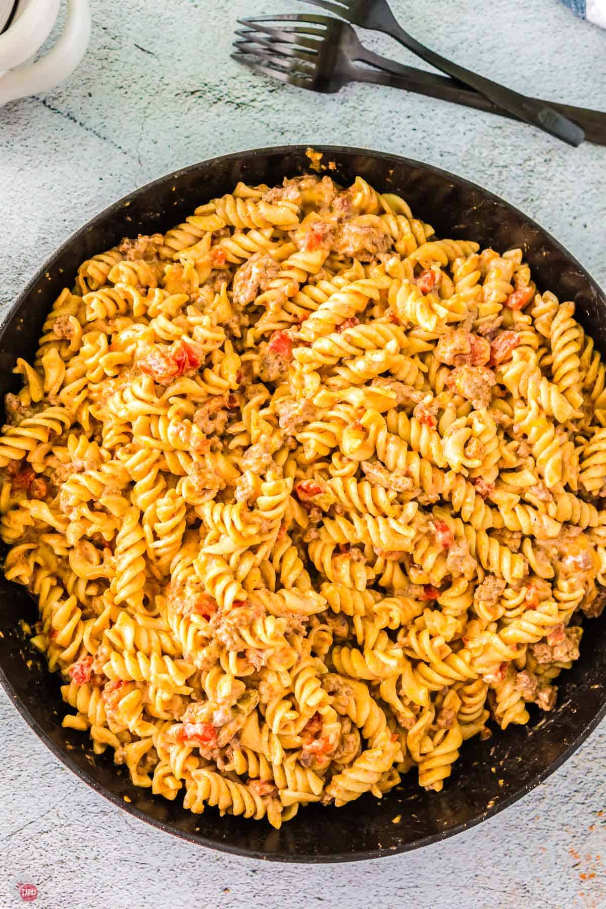 overhead picture of a cast iron skillet with pasta and ground beef