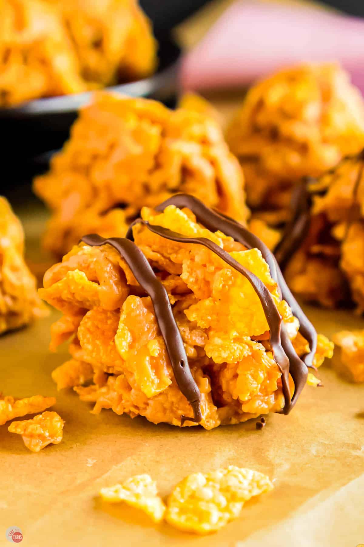 close up of cornflake candy with chocolate drizzled on it