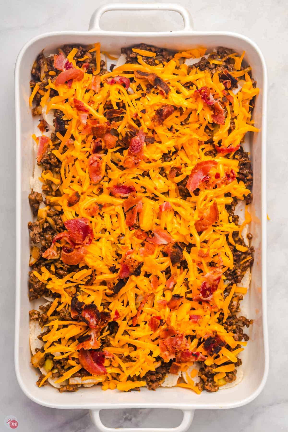 slider buns topped with meat, cheese, and bacon.