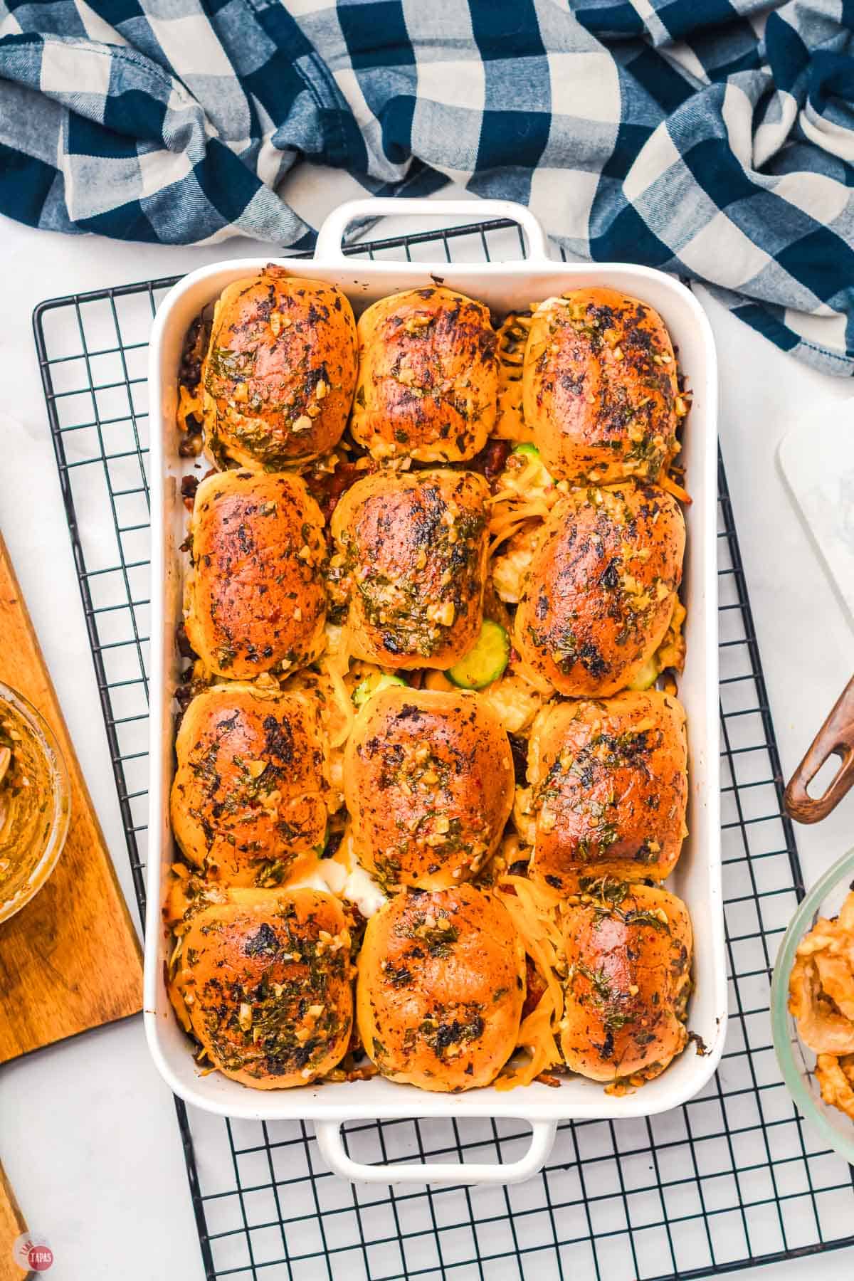 white dish of cooked cowboy sliders on a wire rack
