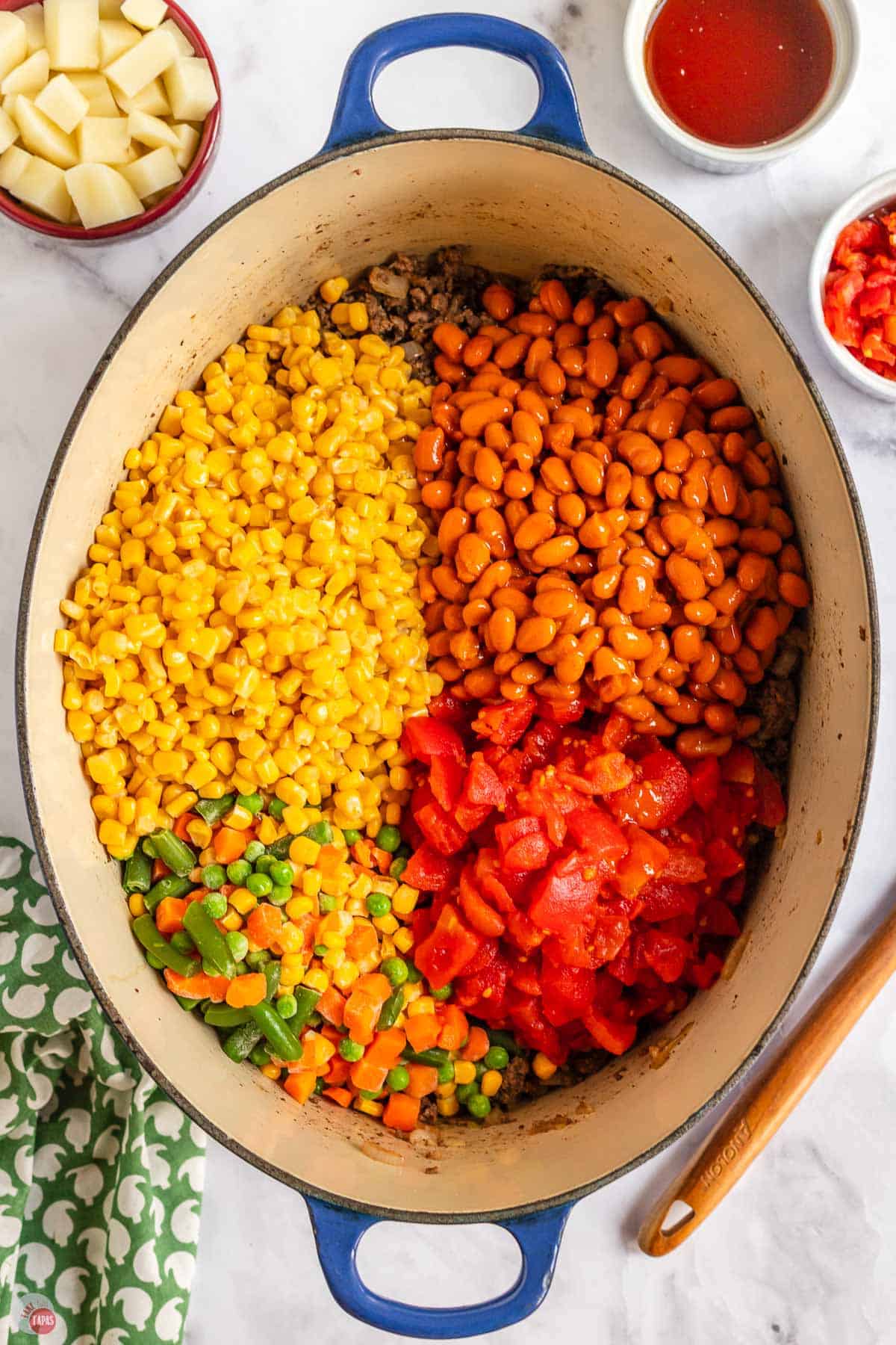 corn and vegetables in a pot with some beans and tomatoes
