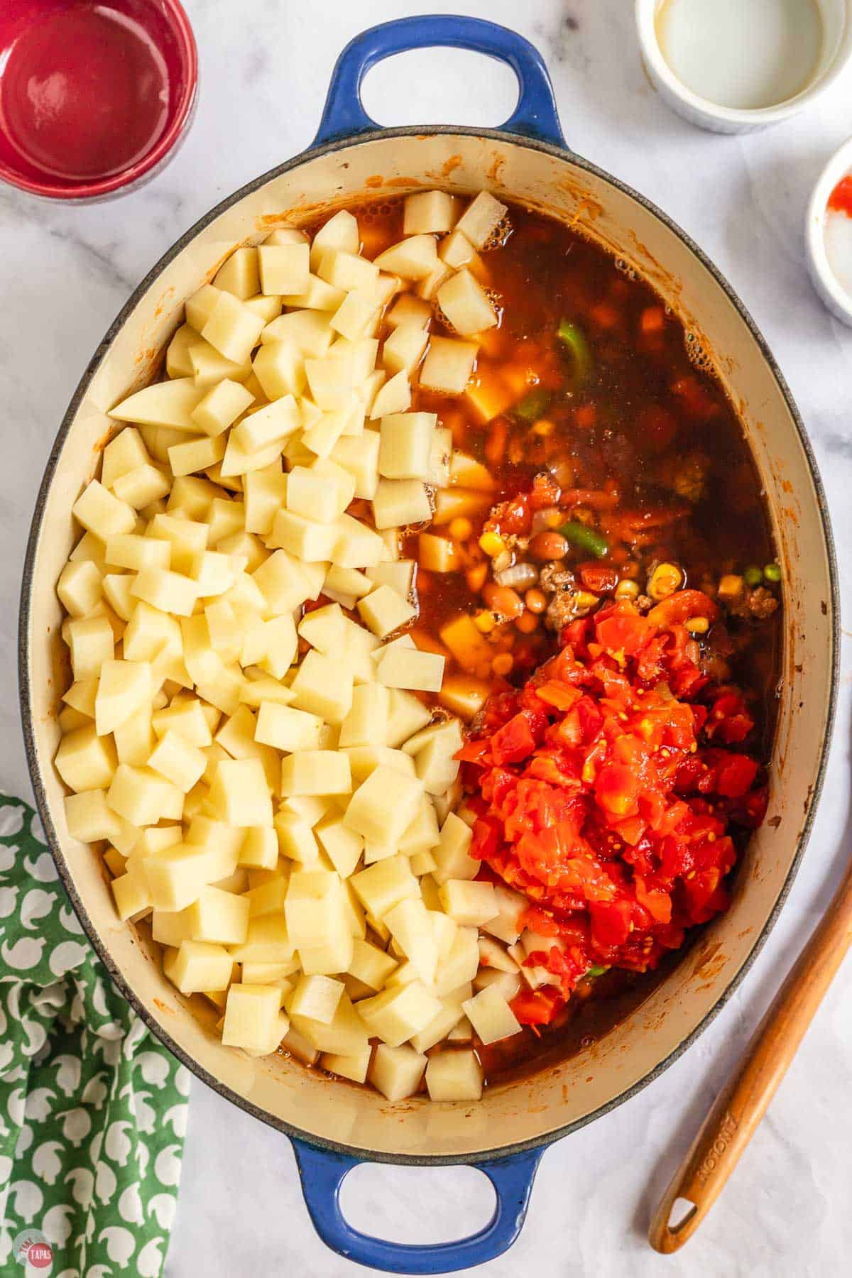 potatoes and diced tomatoes in a soup pot
