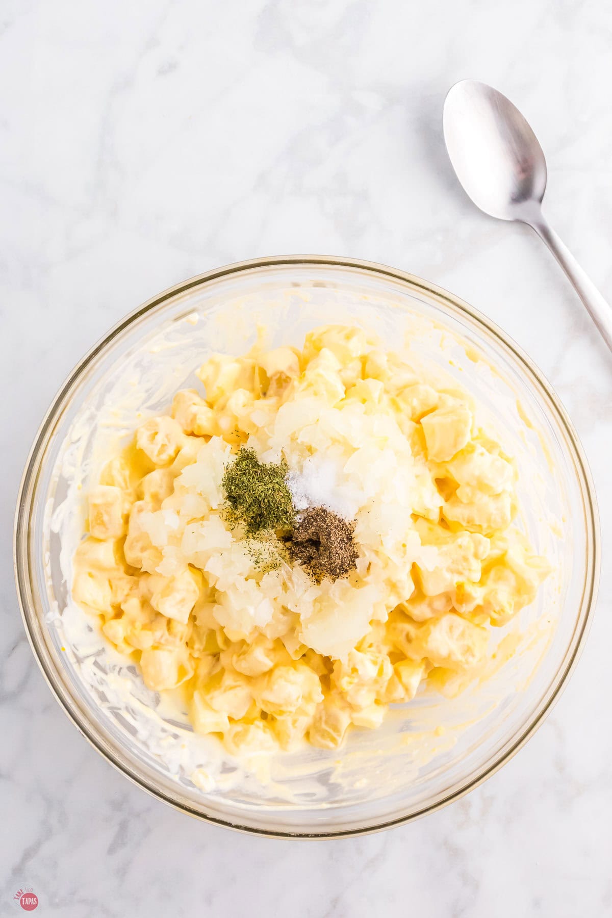 spices on top of a bowl of potato salad