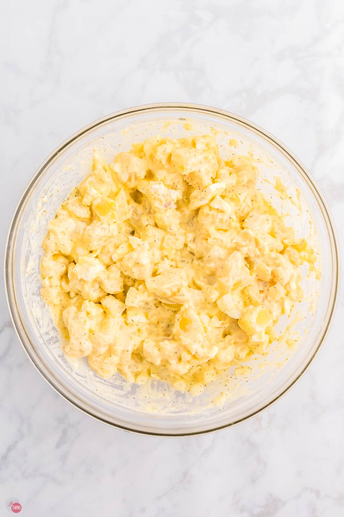 mixed potato salad in a clear bowl