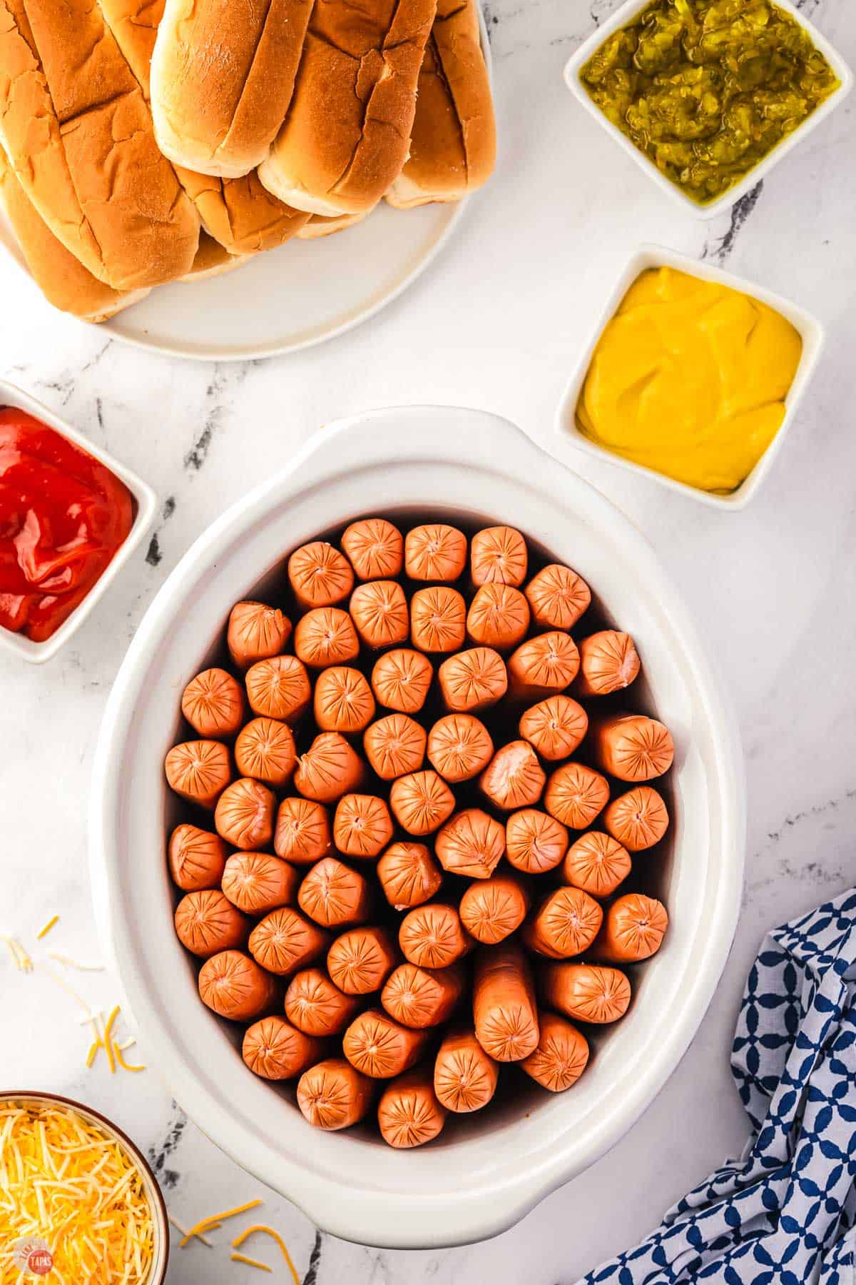 hot dogs standing up in a white crock pot