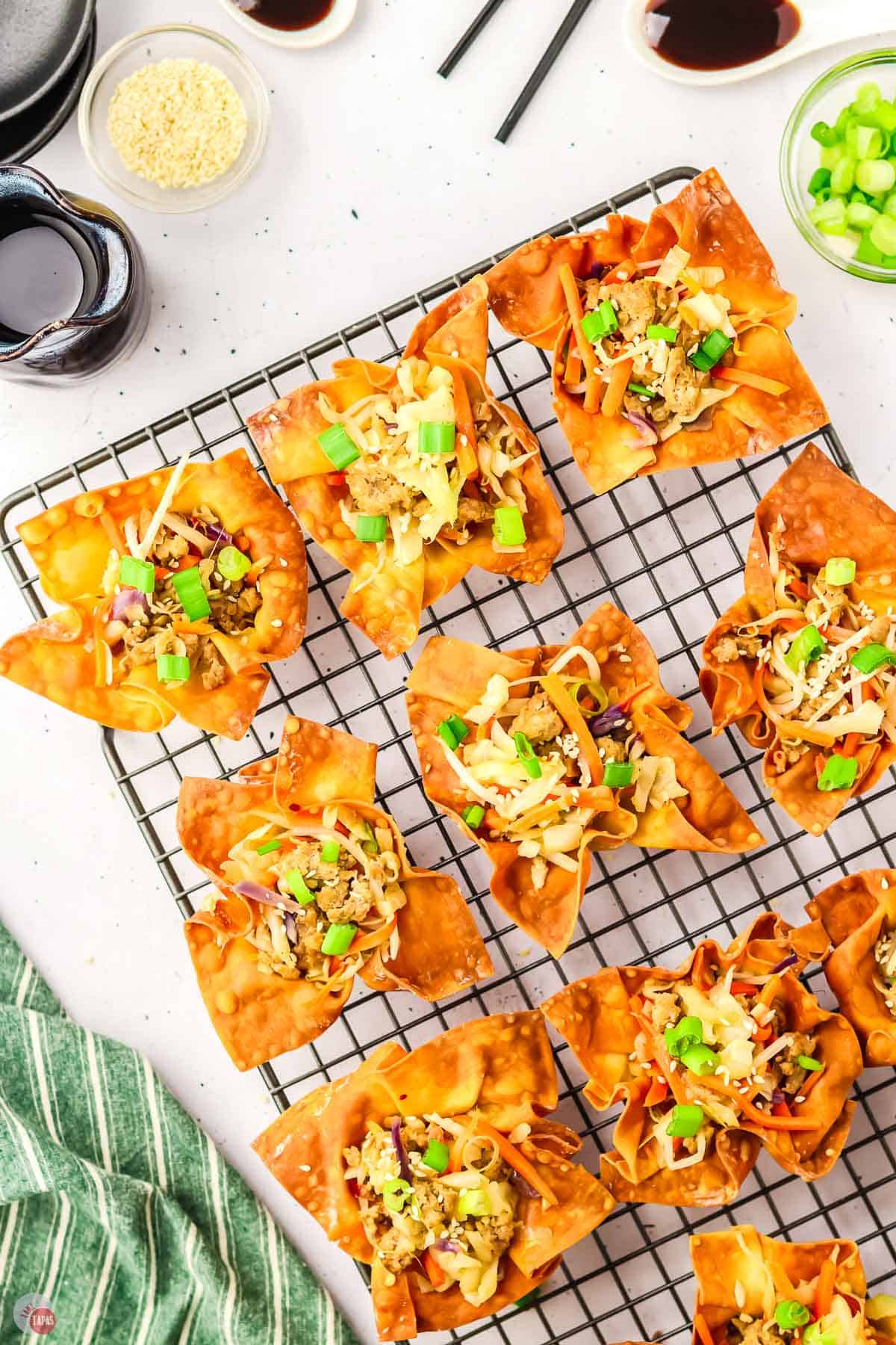 filled egg roll wonton cups on a wire cooling rack
