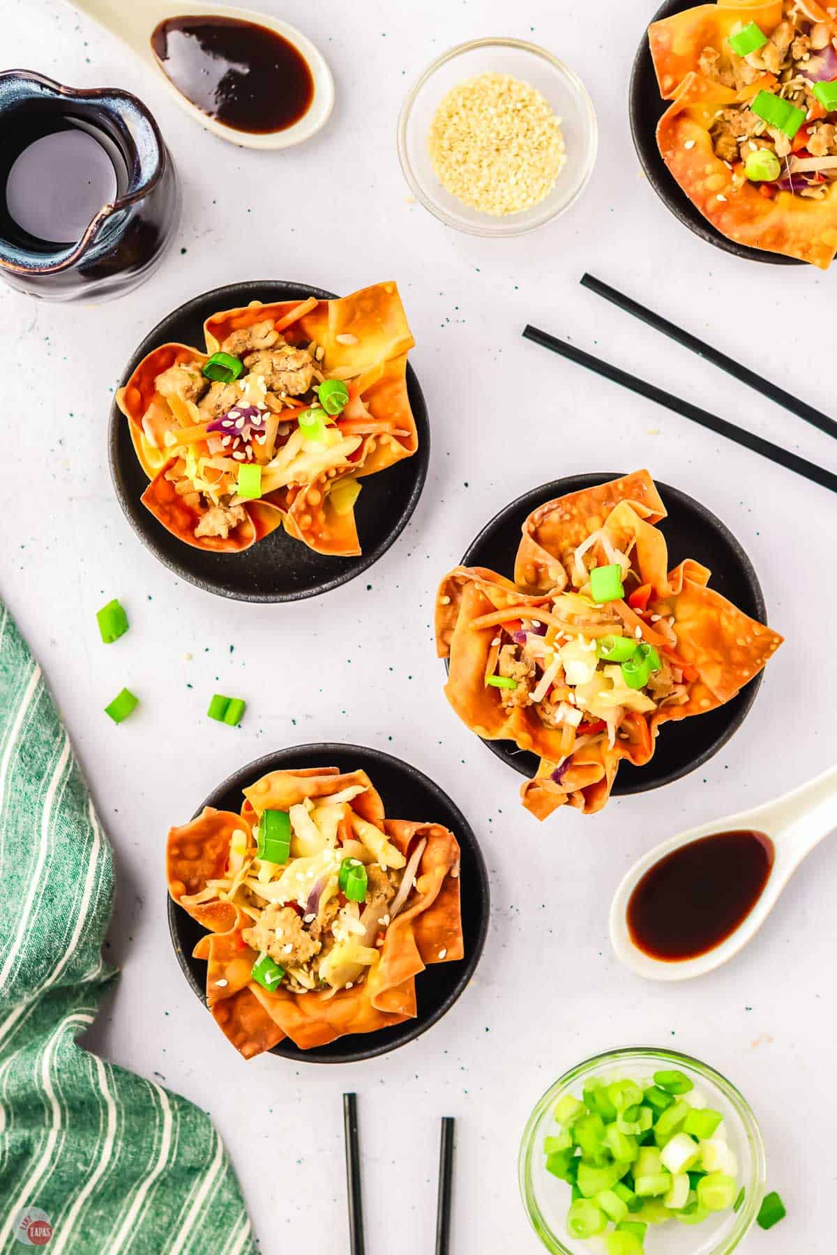 overhead picture of 3 egg roll cups on black plates