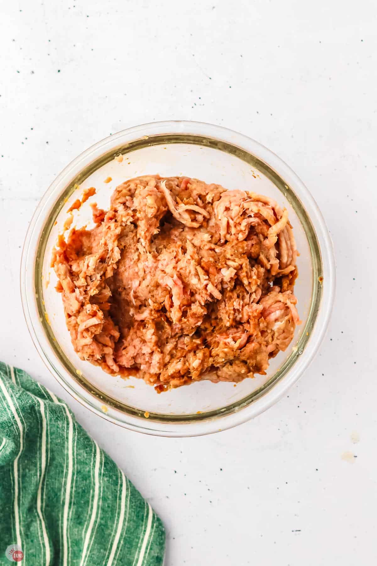 ground chicken and marinade in a clear bowl