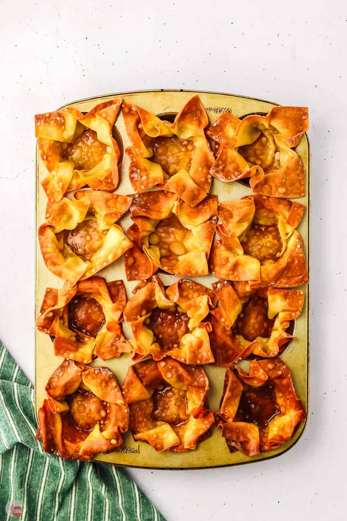 baked wonton cups in a muffin pan