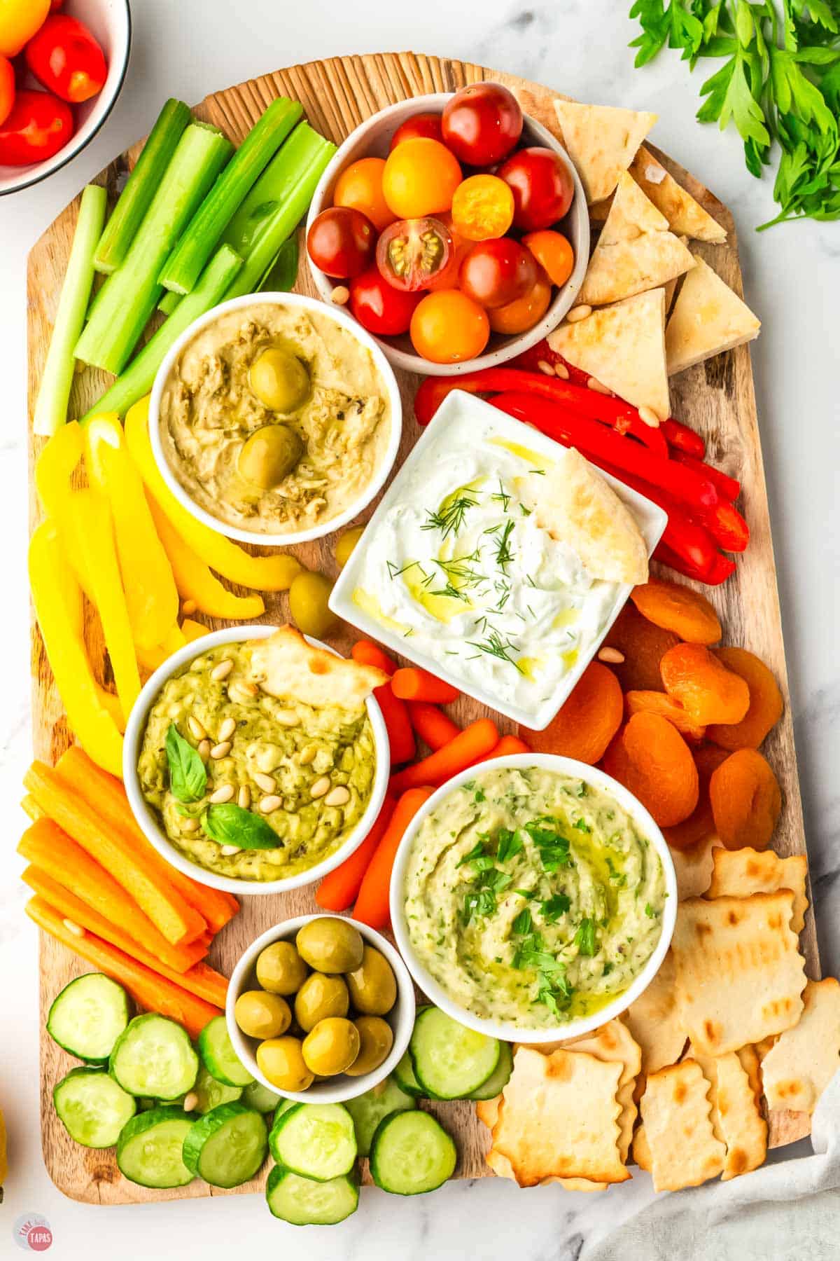 overhead picture of a mezze platter with vegetables and hummus