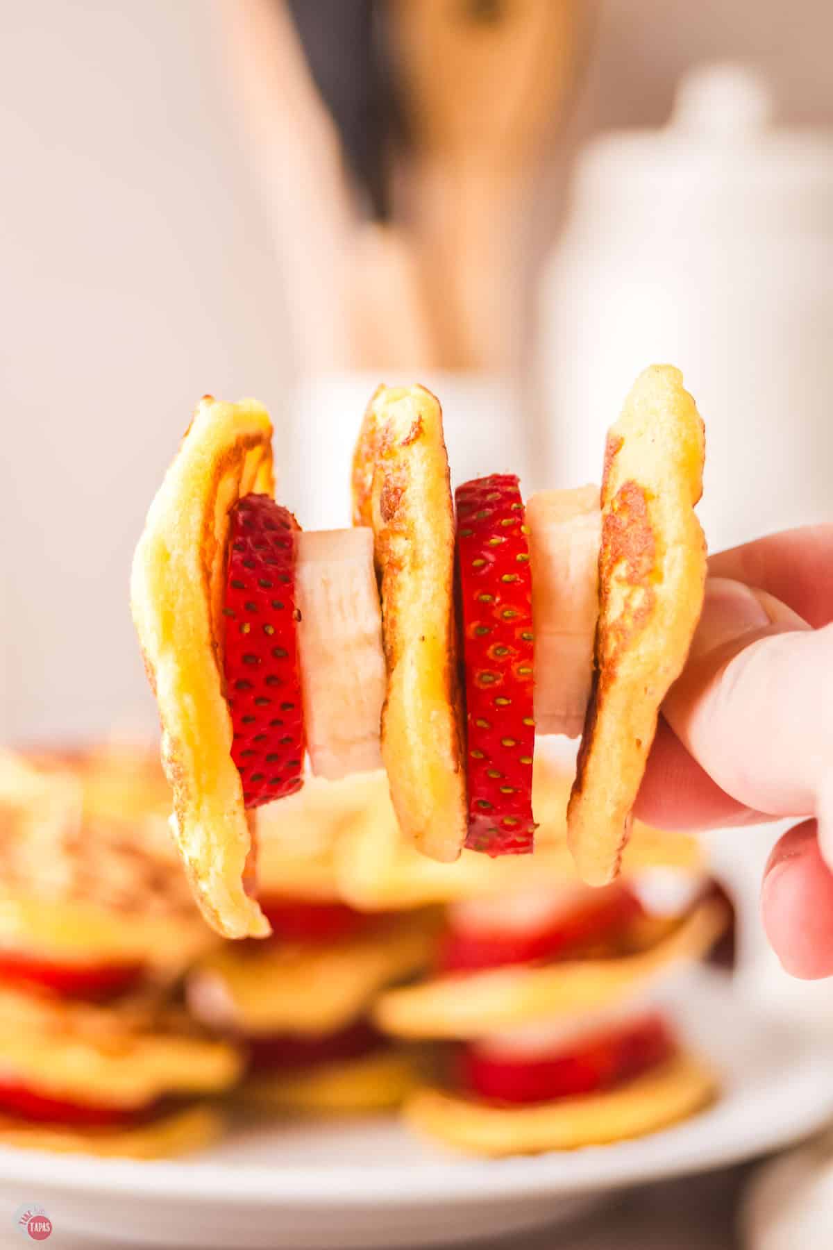 hand holding a mini pancake skewer