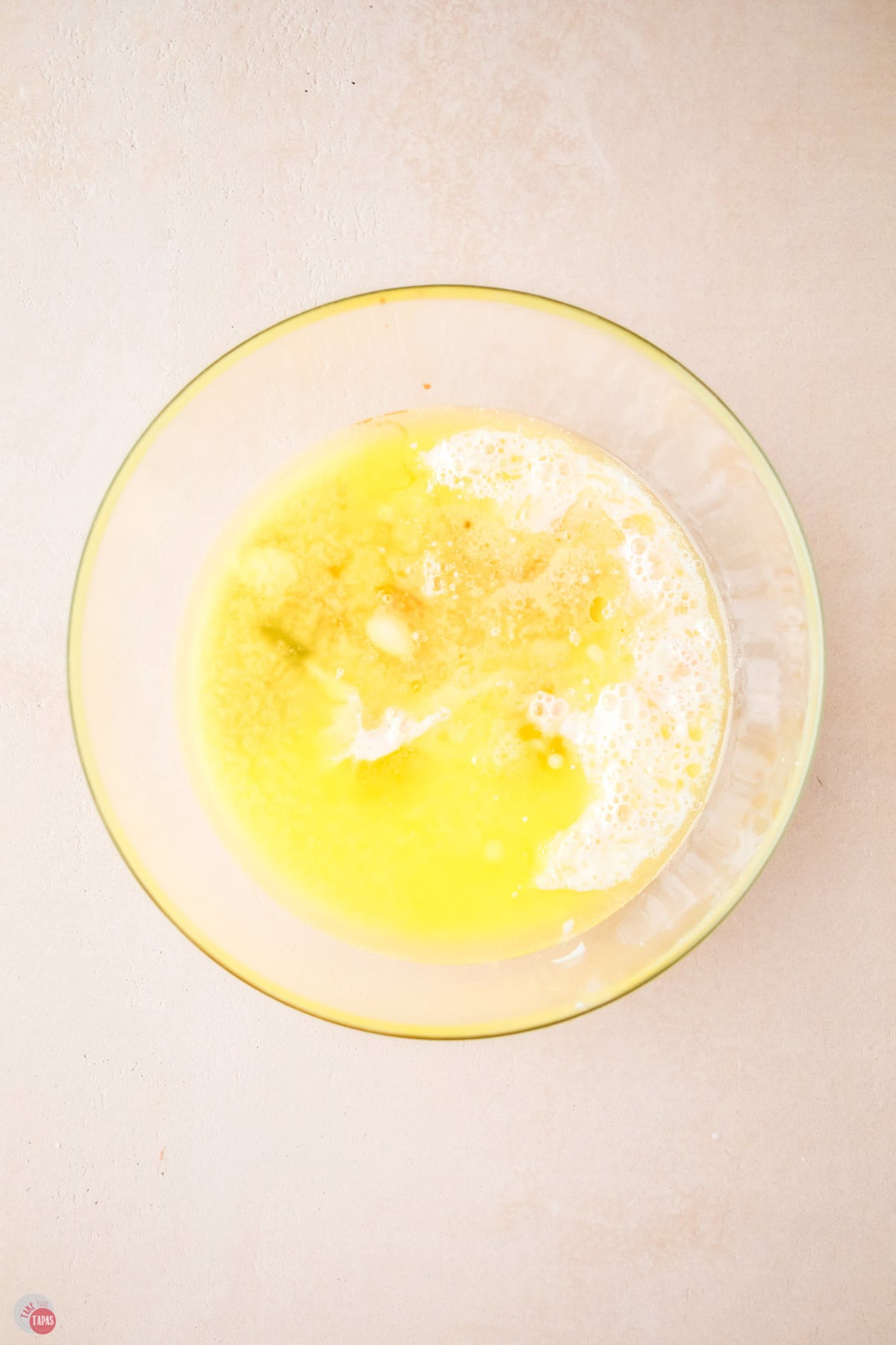 melted butter and flour to make a pancake batter in a clear bowl