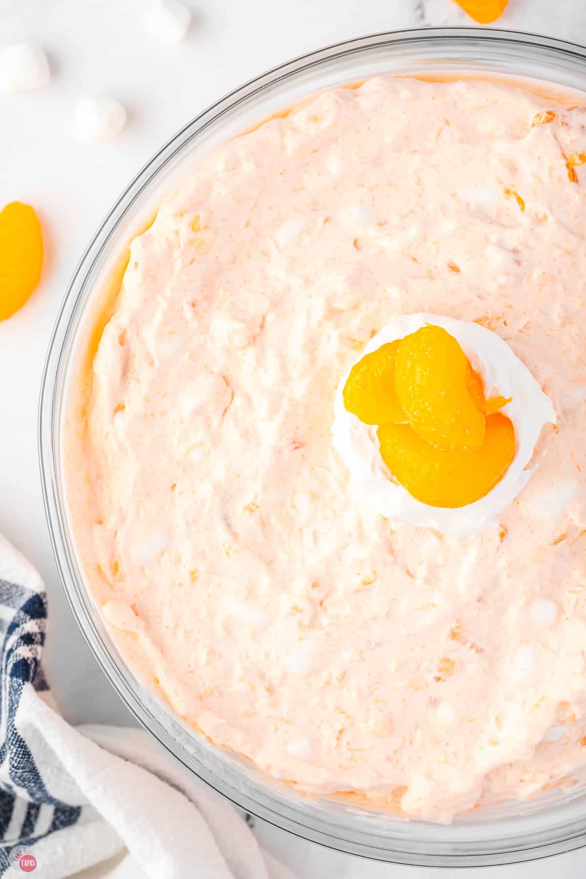 close up of jello fluff salad with oranges on top